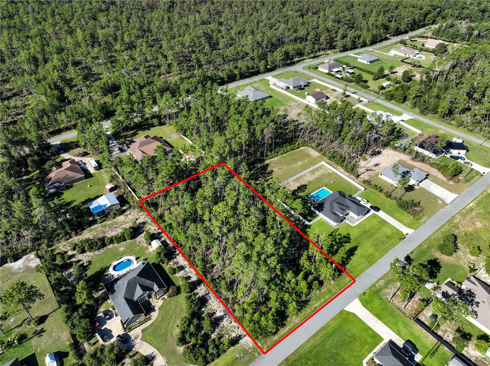 Welcome to a picturesque slice of paradise nestled on 1.25 acres of lush, wooded land. This captivating property boasts a level terrain, offering the perfect canvas for building your dream home. With restrictions ensuring a minimum living area of 2,200 square feet, you'll have ample space to create a sanctuary that is both spacious and luxurious.