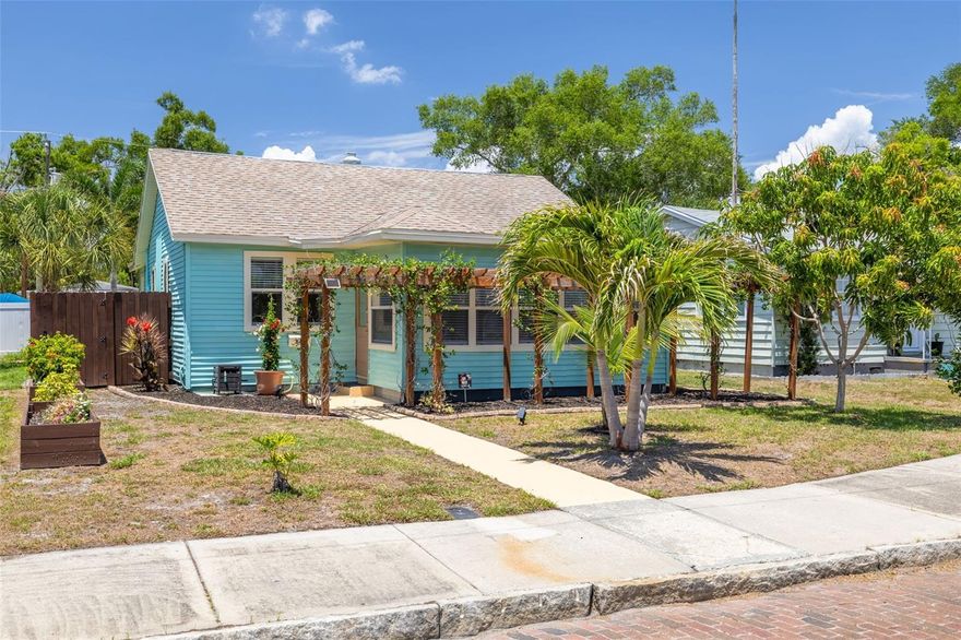 This charming bungalow blends classic character with thoughtful updates and an unbeatable St. Pete location! Offering approximately 1,348 heated square feet, this 3 bedroom, 2 bathroom home features a desirable floor plan, updated kitchen and bath, luxury vinyl plank and tile flooring, fresh interior and exterior paint, double pane windows, and a stacked washer and dryer. Major improvements include a 2019 roof, 2019 water heater, updated foundation, and vinyl siding providing peace of mind for the new owner.  Step outside to enjoy beautifully designed outdoor spaces with tropical landscaping in both the front and back yards. The front yard features a charming pergola surrounded by fragrant star jasmine, a mature mango tree, and drip irrigation for easy maintenance. The fenced backyard is a private retreat complete with artificial turf, patio space, hibiscus, and palm trees perfect for relaxing or entertaining.  The oversized 2 car garage includes additional parking off the paved alley with plenty of space for extra vehicles or even a boat. Conveniently located close to vibrant Downtown St. Petersburg, award-winning beaches, shopping, restaurants, entertainment, and highly sought-after Midtown Academy, a K-5 magnet school known as the Center for Cultural Arts and Gifted Studies, this move-in ready home offers the perfect combination of comfort, style, and Florida living.  Roof 2019 * A/C 2017 * Water Heater 2019 *