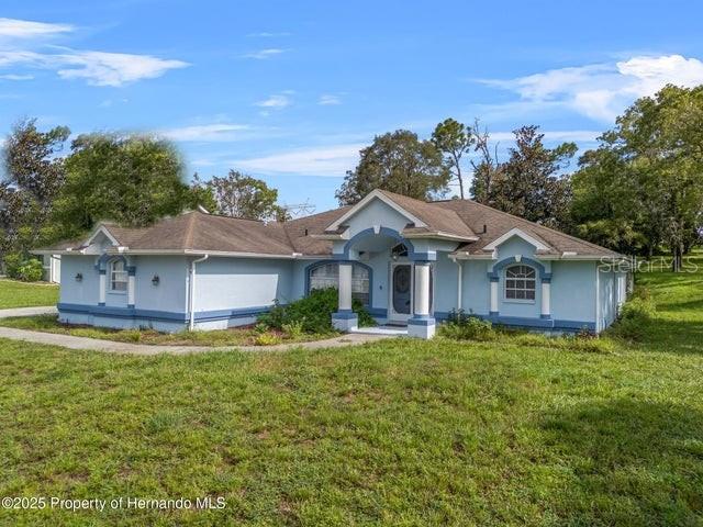 One or more photo(s) has been virtually staged. HARD-TO-FIND 3-BEDROOM POOL HOME ON A HALF-ACRE LOT - FENCED BACKYARD, LOW HOA, AND PRIME SPRING HILL LOCATION! Welcome to 13377 Elise Ln—a rare find in today's market! This 3-BEDROOM, 2-BATHROOM, 2-CAR SIDE-ENTRY GARAGE home sits on a LARGE HALF-ACRE LOT in a beautiful deed-restricted community with sidewalks, mature landscaping, and well-kept larger homes. With a LOW HOA of just 50 annually, you'll enjoy the benefits of a neighborhood without breaking the bank. Step inside and you'll immediately notice—NO CARPET ANYWHERE! The split floor plan makes everyday living easy, with the spacious primary suite tucked away for privacy. The primary bathroom is designed for comfort, featuring HIS & HERS CLOSETS, DOUBLE SINKS, and a GARDEN TUB—the perfect spot to unwind at the end of the day. On the opposite side of the home, you'll find two generously sized guest bedrooms, both with WALK-IN CLOSETS, sharing a full guest bath that also serves as a POOL BATH for convenience. The heart of the home is the open living area that flows right out to the SCREEN-ENCLOSED POOL—ideal for those sunny Florida afternoons. The backyard is FULLY FENCED, giving you plenty of space for pets, gardening, or outdoor gatherings. Updates include a NEWER ROOF and A/C (2013), so you can move in with peace of mind. The location? Unbeatable. You're just minutes from Challenger K-8 Magnet School, close to SR 50 with endless shopping and dining options, and only a short drive to the Suncoast Parkway—putting you in Tampa in about 45 minutes. Enjoy the laid-back lifestyle of Spring Hill and Hernando County, where you'll find parks, golf courses, and the famous Weeki Wachee Springs, yet still be close enough to the excitement, entertainment, and career opportunities of Tampa Bay. If you've been searching for a pool home on a large lot with an excellent location, THIS IS THE ONE.