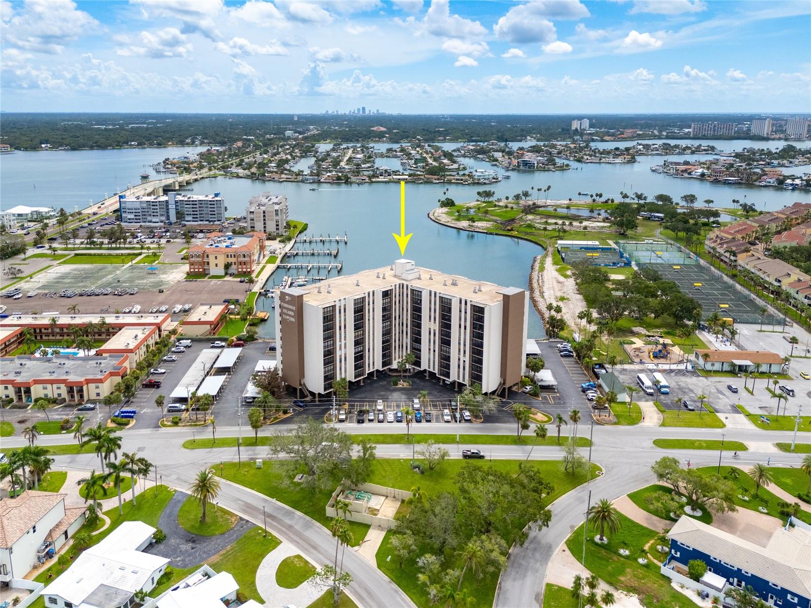 Welcome to Unit #907 at Paradise Island Towers—a rarely available 9th-floor condo offering sweeping views of the Intracoastal Waterway and an unbeatable location just minutes from the beach. This 1-bedroom, 1-bath residence has been owned by the same family since 1977, and it’s ready for its next chapter. With strong bones and classic charm, the unit is the perfect blank slate for a renovation tailored to your taste and lifestyle. A wall of large sliding glass doors leads to your private balcony, where you can relax, unwind, and take in the tranquil waterfront views. The balcony is equipped with electronic hurricane shutters for added peace of mind. Inside, the AC was replaced in 2021, and the dryer is just a year old. The in-unit laundry is thoughtfully tucked inside a walk-in pantry and storage space just off the kitchen—an uncommon perk in similar units. You’ll also find generous closet space throughout, along with an additional private storage unit on the same floor for seasonal or bulky items.
Paradise Island Towers is an established, waterfront community that has recently seen a number of major updates, including fresh exterior paint, brand new balcony screens, updated plumbing, and new elevators. Even more improvements are underway, with the lobby and all residential hallways currently being modernized. Residents enjoy a heated pool and spa overlooking the water, a fishing pier, clubhouse lounge, shuffleboard courts, and on-site management. The marina offers boat slips on a first-come, first-serve basis, and even features a convenient launch area for kayaks and paddle boards—making it easy to embrace life on the water.
Located just minutes from Treasure Island’s wide, sugar-sand beaches and charming downtown, you’ll have everything you need at your fingertips: beach bars, live music, local boutiques, and community events like the Friday morning market. The nearby Treasure Bay Golf & Tennis Club offers golf, tennis, pickleball, and more—just a short stroll from your front door. The 9th floor location offers not only beautiful views but also a sense of quiet and privacy, removed from the bustle below. If you’re looking for a well-maintained building with strong amenities, a vibrant coastal town, and a condo you can truly make your own—this is it.