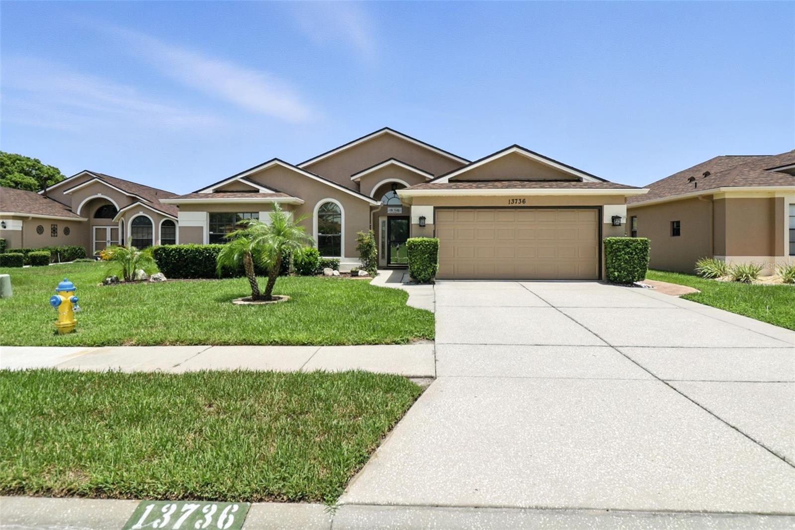 Welcome to this beautifully customized 2-bedroom, 2-bath, 2-car garage home offering over 1,900 sq ft of usable space in the desirable Preserve at Fairway Oaks community in Hudson, Florida. Originally built with 1,622 sq ft of living space, interior modifications completed in 2016 expanded the livable area beyond the recorded 1,650 sq ft on tax records. This home is full of thoughtful upgrades both inside and out and has been meticulously maintained and perfect for entertaining your family, friends and guests. Step inside to an open floor plan featuring volume ceilings that allow natural light to flood the home. The kitchen is a chef’s delight with granite countertops, a breakfast bar, ample cabinetry, and an oversized walk-in pantry. Plantation shutters, built-in features, and a charming window seat with storage in the dining room add both character and functionality. The great room and master bedroom boast updated flooring that brings warmth and cohesiveness to the space. Both bathrooms feature matching granite counters, and the master bath has been completely remodeled with elegant custom tile and sleek glass shower doors. Additional highlights include a versatile den/office, which could easily be a 3rd bedroom, a separate laundry room with a utility sink, and a spacious layout that blends comfort and convenience. Enjoy the added bonuses of the paver sidewalks and patios that wrap their way around the exterior of the home and throughout the network of the many fruit trees and beautiful landscaping and the privacy with no rear neighbors—a rare find. The Preserve at Fairway Oaks is a welcoming and well-kept community offering a peaceful lifestyle.
This community offers natural gas which fuels the 50 gallon water heater and the furnace. Towering ceilings, upgraded ceiling fans, stunning laminate flooring throughout, tile in the customized rooms, a video doorbell, lighting on wi-fi command, keyless entry, handicapped accessibility, large walk in closet and plenty of cabinet space (check out the garage) these are all extra reasons to love this home. The large capacity washer and dryer in the laundry room are included as well.
Don't miss your chance to tour this lovely, move-in-ready home today!
