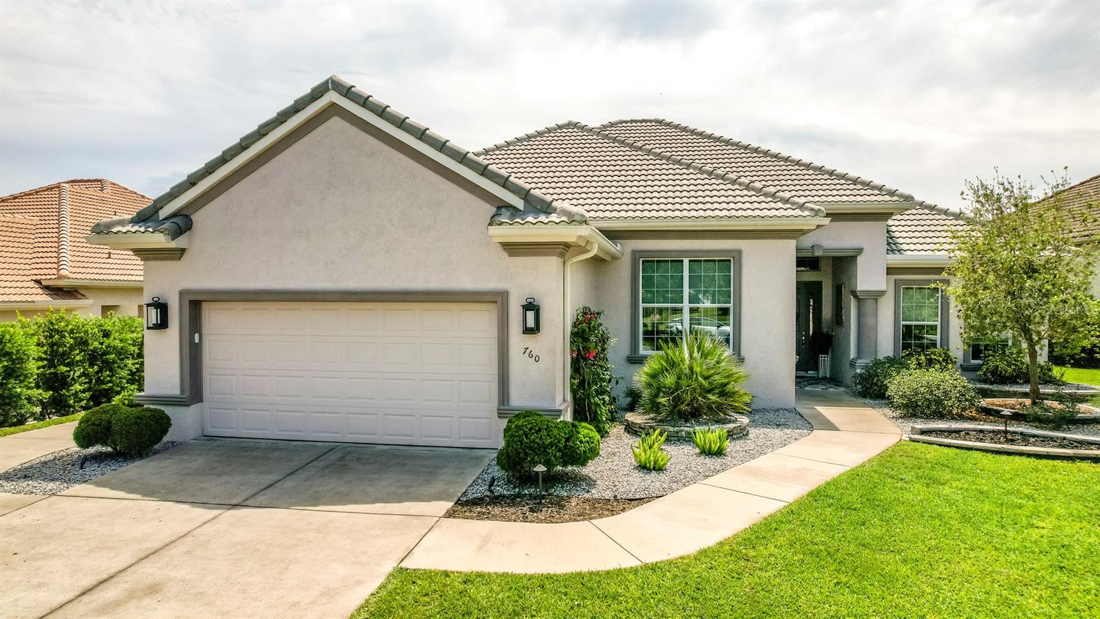 Welcome to this stunning custom-designed Newcastle model, where elegance, comfort, and thoughtful design come together seamlessly. Built in 2020, this immaculate home showcases an open-concept great room with tray ceilings and upgraded lighting, all framed by full pocket sliding glass doors that open completely to a serene lanai with amazing views —perfect for effortless indoor-outdoor living. From the moment you enter, you’ll appreciate the upscale finishes, including stylish accent walls, beautiful tile flooring, upgraded carpet, and custom window treatments. The gourmet kitchen is a true centerpiece, featuring Cambria quartz countertops, a granite island ideal for gathering with friends, stainless steel Whirlpool appliances, and ambient accent lighting. Matching built-in cabinetry with quartz surfaces in the great room adds to the home’s cohesive flow. Retreat to your spacious master suite, complete with three professionally designed custom closets and a private 335-square-foot bonus room—ideal for a home office, gym, or sitting area. Every closet in the home has been custom-designed for optimal organization and style. Additional highlights include a dedicated golf cart garage door and meticulously maintained interiors that feel better than new. Located in the amenity-rich community of Terra Vista, this exceptional home invites you to live the lifestyle you’ve always dreamed of.