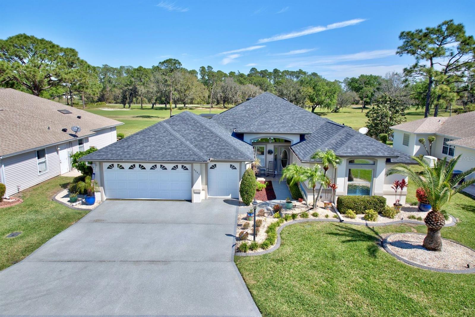 Ready to live the Florida dream in a remarkable Highlands Ridge custom home? Located on a desirable lot in a gated 55+ community, this place has so many upgrades and reasons to fall in love. The beautiful view from the spacious back porch overlooks the pool and the wooded area with a small pond near by. Cedar wood has just been added to the porch ceiling as a natural and lovely addition. The screened-in pool has a new heater, pool pump, and filter. This pool setup gives you the option to heat the water with solar or a heater. New carpet has been installed on the back porch. A new whole home generator and a buried propane tank have recently been added along the cameras and a security system. This custom home has 2 bedrooms PLUS an office or den. This room has been recently updated with new paint, baseboards, and flooring. The home has 2 bathrooms plus a shower in the garage for the half bath. The guest suite has a pocket door for privacy. The living area is well designed with natural lighting and appealing colors plus great built in shelving and cathedral ceilings. Brand new high-end vinyl has just been installed throughout much of the living area. There are 2 sets of sliding glass doors for easy entry to the back porch. The kitchen has white cabinets with a great sized island and quartz countertops There are 2 optional dining areas. The master suite has a well designed configuration for the bed and natural lighting over looking the pool. There are two walk-in closets and a spacious bathroom that has double vanities and a walk-in shower with a low threshold. Plantation shutters has been installed throughout the house. There is a nice laundry room connected to the garage with a washer, dryer, and a second refrigerator. The 2 car + golf cart garage has so much space for vehicles, toys, and even a work area. The garage has been recently painted. The highly sought after Highlands Ridge provides an abundance of activities such an 18-hole golf course, community pool shuffleboard, pickleball, card games, and a restaurant in the community. The monthly fees for the Homeowners Association encompass lawn maintenance, road upkeep, and access to all facilities within the community. The remarks on this home could go on and on.... It is truly a dream home in such great condition in a wonderful location!