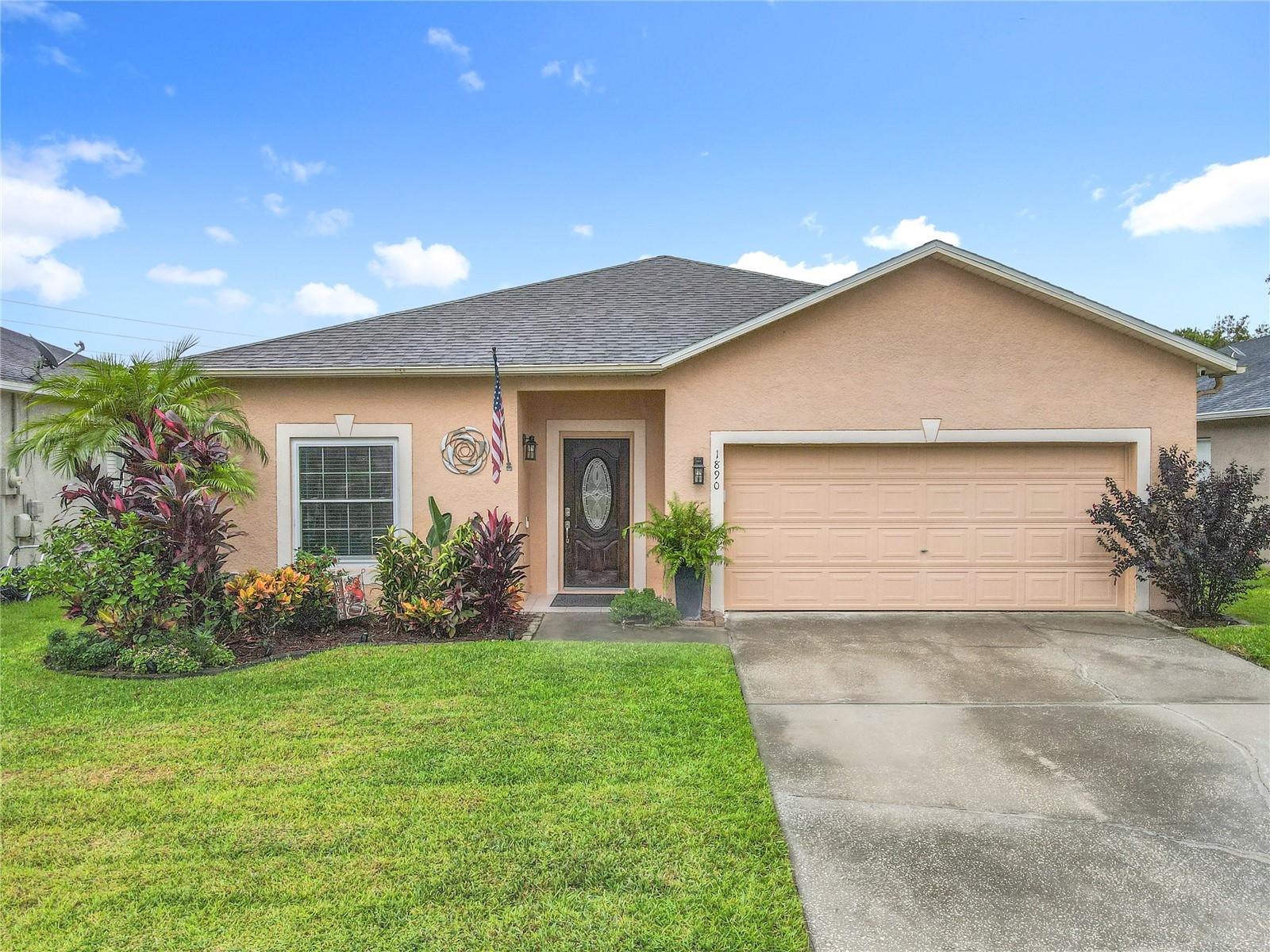 Welcome to this adorable 3-bedroom, 2-bathroom gem in the heart of Oviedo, boasting 1,544 square feet of inviting living space plus a versatile enclosed tiled porch with built in TV cabinet—perfect as a screened room for breezy evenings or a cooled retreat with windows closed, portable AC, and ceiling fan on those warm summer days. With a 2-car garage and no rear neighbors, enjoy ultimate privacy in your fenced backyard, complete with freshly updated landscaping front and back, and a serene pond and trees just beyond the fence. Step inside to newly grouted tiled floors throughout, except for one bedroom featuring cozy carpet and French doors—ideal for a home office. The open living/dining room combo offers ample space for entertaining, enhanced by a stylish picture frame molding accent wall. The kitchen shines with newly painted gray cabinets, 2019 stainless steel appliances (including a brand-new 2025 dishwasher), and a charming barn door leading to the closet pantry. Retreat to the primary bedroom, overlooking lush tropical foliage, with an accent wall of decorative molding, ceiling fan, and a spacious walk-in closet with built-in shelves. The en-suite bathroom impresses with a separate tub and shower stall, updated dual-sink vanity, mirrors, and lighting. Two secondary bedrooms feature new ceiling fans, while the inside laundry room includes newer cabinets, washer, and dryer for added convenience. Modern upgrades abound: knock-down ceilings with crown molding, fresh interior paint, new exterior motion lights, 2023 double-pane Energy-Star windows and sliding glass door, a 2025 hybrid water heater, 2018 roof, and a 2021 AC unit with UV light (air handler boasting a new return deck) and smart thermostat. Nestled in wonderful Oviedo with zoning for top-rated Seminole County schools, this move-in-ready home is ready for you!