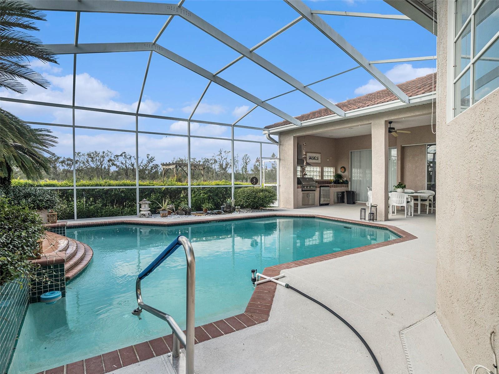Price Drop! The seller is motivated. This property offers the perfect blend of space and freedom, located in the desirable Hillsborough area with no HOA and no CDD fees. Enjoy ample room to roam and the ability to bring all your toys—whether it's RVs, boats, or other recreational vehicles. Don’t miss out on this chance to own a slice of Hillsborough without the restrictions! The pool and pool decking freshly resurfaced. The outdoor kitchen has a new stainless steel mini fridge installed. Surrounded by a cattle ranch is a 22-acre property, 10 acres of which is inactive vineyard. The main house is a 2,914 square foot (under roof) Mediterranean style, single story with 9 rooms. There are 4 bedrooms and 3 full baths. A vaulted family room, kitchen, dining room, living room, den, and breakfast nook make up the remaining rooms. All ceilings are 10 feet high, except for the family room that vaults to 14 feet and front entryway which has a 12-foot ceiling. Vinyl flooring can be found in the study and tile in the kitchen and bathrooms while the rest of the house has bleached oak wood floors. A three-car garage, a screened in pool and spa, and a lanai equipped with outdoor grill, sink and refrigerator, complete the layout of the home. This beautiful Arthur Ruthenberg inspired home is perfect for its placement, surrounded by lush oak trees with windows and sliding glass doors that look out on the green yard. Additionally, the property has 7 acres of untouched woods with a stream running through it and a small trail to view untouched Florida. There is a second wood frame house that can be used for visiting guests, or parents’ home. It is 1052 sq. ft. with 2 bedrooms, 1 bath, a living room, kitchen and a front porch. A large-sized enclosed shed with a sheltered area is used for all the equipment and tools used to maintain the property. An 18' x 24' Greenhouse and a 12' x 24' Shade house are on the property. Appliances included dishwasher, dryer, garbage disposal, microwave, range/oven, refrigerator, washer, wine fridge. Don't miss out on the chance to own this home and immerse yourself in the serenity, functionality, and tranquility of perfect harmony. Preferred lender is offering special financing incentives towards closing costs and rate buydowns.