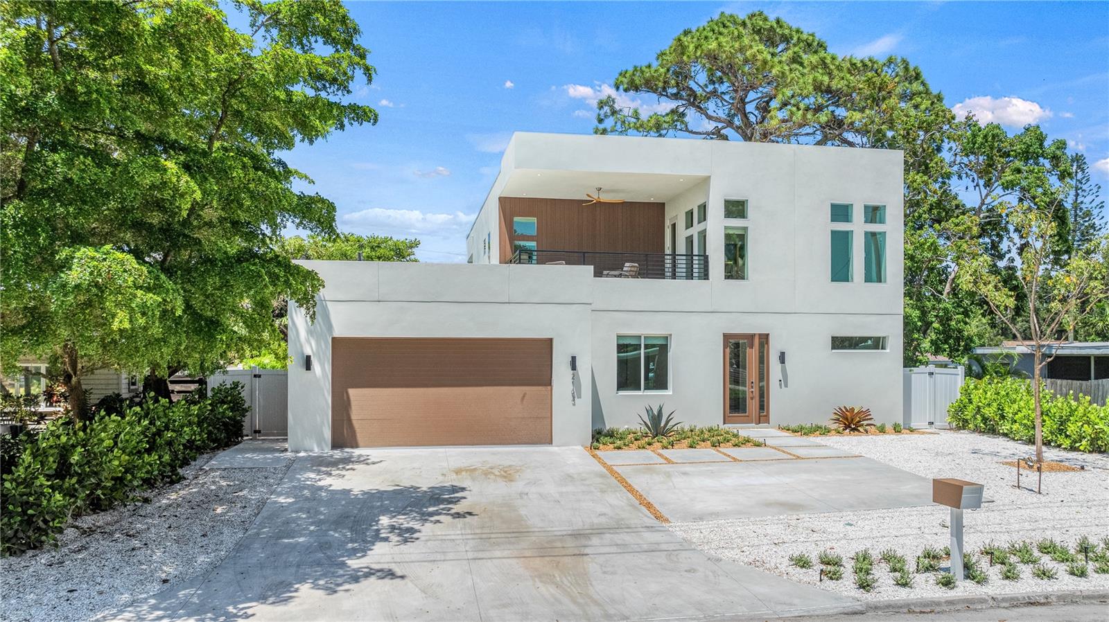 Experience modern Sarasota living at its finest in this stunning five-bedroom, five-and-a-half-bath residence located in the heart of Arlington Park. Designed for style and comfort, this exceptional home offers a bright, open floor plan and a seamless indoor-outdoor lifestyle just minutes from Siesta Key, downtown Sarasota, and St. Armands Circle.
The gourmet kitchen serves as the centerpiece of the home with a spacious island, premium appliances, and contemporary finishes ideal for both daily living and entertaining. The adjoining living and dining areas feature clean lines and abundant natural light, creating an inviting flow throughout the main level.
Each bedroom suite provides generous space and privacy, including four king suites and a flexible fifth suite with a queen and twin bunk—perfect for guests or multi-generational living. Designer bathrooms with custom tilework and upscale fixtures deliver a spa-inspired experience.
The outdoor spaces elevate the property even further with a heated pool and spa, summer kitchen, fireplace, and putting green. A rooftop deck expands the living area with panoramic views and room for sunset gatherings. Additional highlights include a game room, multiple patios, and ample parking.
Set within one of Sarasota’s most convenient neighborhoods, this home combines luxury design, entertainment amenities, and proximity to everything the Gulf Coast has to offer—an ideal choice for a full-time residence, vacation escape, or investment opportunity.