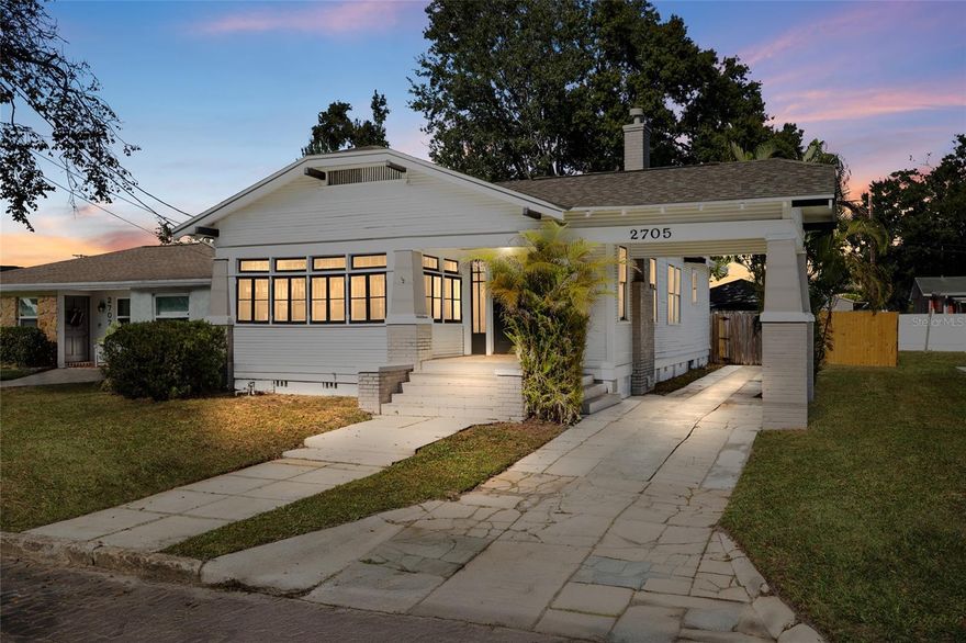 Step into the charm of a 1920s West Tampa bungalow that blends historic details with modern updates. With 10-foot ceilings, original windows framed in period moldings, an iconic attached portico, plaster walls, crown molding, and a cozy wood-burning fireplace, the home captures everything people love about true bungalows. You’ll also enjoy new flooring, a beautifully updated kitchen with granite counters, solid wood cabinetry, stainless appliances, and a built-in breakfast nook. The layout offers three bedrooms, two baths including a primary ensuite, a light-filled bonus room, indoor laundry, and a fully fenced backyard perfect for relaxing or entertaining. Major updates: 2022 roof, 2023 HVAC, updated plumbing and electrical and an electric tankless water heater giving you modern updates where it counts most. Directly across from a park and playground and minutes to I-275, Ray Jay, Armature Works, Tampa Airport, Downtown, Midtown, the food scene and local restaurants, this home sits in one of Tampa’s most convenient and growing neighborhoods. Floor plan available.