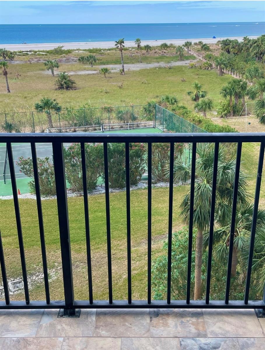 5th floor END UNIT with direct oceanfront Gulf views, located in Landmark Towers on the famous Sand Key Beach. This freshly remodeled 2-bedroom, 2-bathroom condo offers 1,111 square feet of living space and includes Quartz countertops, new cabinetry, recessed lighting, LVP flooring, and extra in-unit storage. An in-unit washer and dryer adds convenience, and the primary bedroom features a walk-in closet and a sliding glass door to the balcony with stunning ocean views. The unit also includes impact-resistant double-pane windows and a spacious layout ideal for everyday living or seasonal use. Enjoy direct views of the beach, pool, and tennis courts from the main living areas. Amenities include a HEATED POOL, SPA, TENNIS COURTS, SHUFFLEBOARD, BBQ GRILLS, and a PRIVATE BEACH RESERVE WITH DIRECT GULF ACCESS via a boardwalk through the community’s conservation area. A PREMIUM COVERED PARKING SPACE NEXT TO THE ELEVATOR. The monthly condominium fee covers WATER, TRASH, BASIC ELECTRICITY, CABLE, INTERNET, EXTERIOR MAINTENANCE, and 24/7 SECURITY WITH GATED ENTRY AND ON-SITE MANAGEMENT. Landmark Towers is located just across the street from Sand Key Plaza, placing shopping and waterfront dining options—including the famous Columbia Restaurant—only steps away. Approximate travel times: 5 minutes to Clearwater Beach, 15 minutes to St. Pete–Clearwater Airport, and 30 minutes to Tampa International Airport.