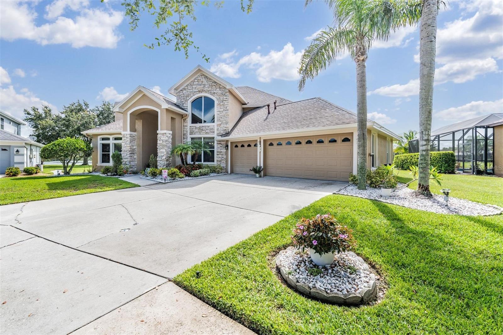 Tucked away at the end of a quiet cul-de-sac in the exclusive gated enclave of Strathmoor Estates, this home gives the peace and privacy you've been waiting for. With 4 bedrooms, 4 bathrooms, dedicated office space, oversized loft, tranquil pond views, a private pool, over 3,200 square feet of living space on a third of an acre lot, this home blends everyday functionality with timeless comfort making it a perfect fit for both relaxed living and effortless entertaining. From the moment you walk in, you're greeted by soaring ceilings, an abundance of natural light, and a layout designed with intention. The formal dining room sets the stage for holiday dinners and celebrations, while the dedicated home office offers the quiet and separation today's work-from-home lifestyle demands. A spacious upstairs loft provides room to spread out—ideal for a game room, secondary lounge, or guest overflow. At the heart of the home is an open concept kitchen that overlooks the living area and pool beyond. It’s a warm and inviting space featuring granite countertops, custom cabinetry, and updated appliances, perfect for everything from morning coffee to weekend gatherings. Step outside to the screened lanai and enjoy your own private retreat, where the pool and pond views provide a peaceful escape from the everyday. Recent updates and improvements include kitchen cabinets and granite countertops (2014), a newer roof (2015), exterior (2017) and interior paint (2021), updated showers in both the primary and pool bathrooms (2020), new carpet (2021), newer washer and dryer (2021), new kitchen appliances including a refrigerator (2024) and dishwasher (2023), two new A/C units (2024), a new pool motor and filter (2024), added gutters (2023), and a recently replaced water heater (2023), reflecting a home that has been carefully maintained. As a resident of West Meadows, you’ll have access to an impressive lineup of resort style amenities, including a heated lap pool, family pool with water slide and splash pad, lighted tennis courts, newly added pickleball courts, basketball and volleyball courts, soccer fields, walking trails, playgrounds, a fitness center, and even a dog park. Conveniently located near top-rated schools, I-75, shops, dining, and everything New Tampa provides, this is the kind of property that delivers both value and lifestyle in one exceptional package.