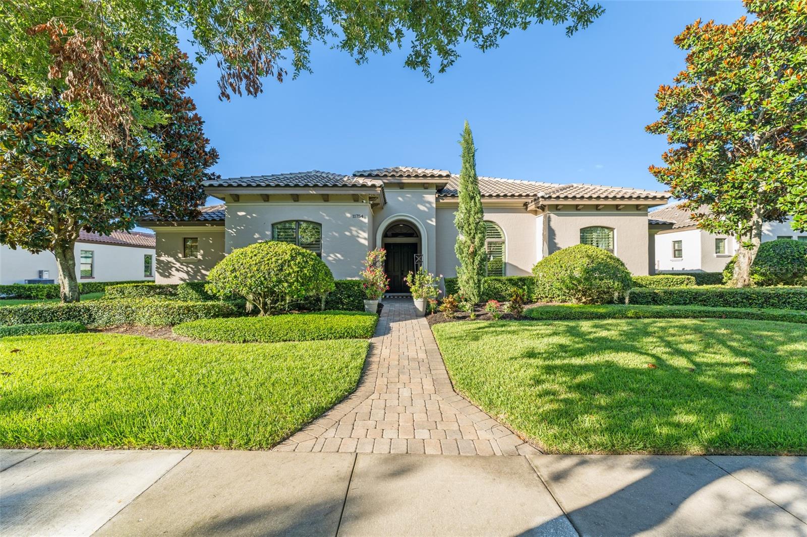 Exceptional single-story Silliman-built home in the 24-hour guard-gated community of Waterstone, adjacent to Windermere Prep. Boasting 4 bedrooms, 3 bathrooms, and an open-concept floorplan with luxury details throughout, this residence is truly designed to impress. Glass sliders in the Great Room reveal a spectacular resort-style oasis beyond with infinity saltwater pool and spa with lighting, paver Travertine decking, covered lanai and detached cabana with retractable screens, outdoor grilling area, fire feature, and grass-free enclosed courtyard for maximum privacy. Interior spaces are adorned with Travertine flooring, custom lighting, custom premium window treatments by Hunter Douglas and attention to detail. The Great Room is fitted with a gas fireplace, built-ins, stacked natural stone inlay wall, and rich-looking wooden beams in the ceiling with custom lighting. The chef’s kitchen features thick quartz countertops and an island with a sink equipped with an auto touch faucet and breakfast bar. The Bosch appliances include a five-burner gas cooktop, built-in oven, microwave, dishwasher, and a refrigerator. The large pantry is conveniently hidden behind the kitchen. The sumptuous breakfast nook is a favorite spot for gatherings. The primary retreat sets the standard for luxurious living with double door entrance, walk-in closet, sliding doors into the extended pool deck, and an updated spa-like master bathroom that features stand-alone garden bathtub, double vanities, and glass-enclosed shower. Bedrooms 2 and 3 feature a jack-and-jill-style shared bathroom. Community features a private walkway directly to Windermere Prep. Close to Winter Garden Village, SR429, Walt Disney World, and easy access to downtown Orlando, Florida’s Turnpike, and Central Florida’s famed attractions.
