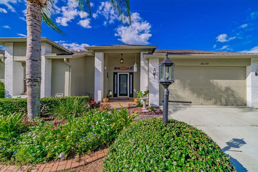 Beautiful 2 bedroom 2 bath corner lot villa in the gated, sought after Heritage Pines Country Club.  This 55 and up community has the luxury lifestyle anyone would want without breaking the bank. Peace and quiet await if you wish OR activities are steps away. 18 hole Golf Course, fitness center, swimming, tennis, crafting, woodworking, pickleball, bocce just to name a few.  This open floor plan villa has a view of beautiful trees that your screened lanai look out on.  Split bedroom plan.  En-suite attached to the owners quarters with a beautiful skylight to light the night. Eat in kitchen with separate laundry room with sink.  Formal dining room or bonus room, you choose.  This is a must see to appreciate this home and community you have always wanted at a very affordable investment.  Close to beaches and Tampa Airport. New owner will have a mandatory deposit $927 directly to the HOA upon closing.