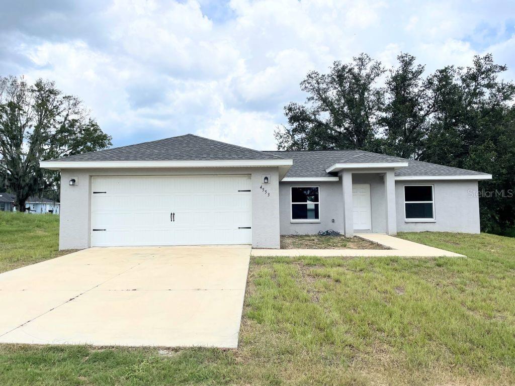 Situated on a nearly one-third acre lot with no HOA, this single-family home has enough room for boat or RV parking. This neighborhood is attractive to investors because it has no leasing restrictions, so this home can be rented out either long-term or short-term. The interior features an open floor plan with high ceilings in the living/kitchen/dining area and luxury vinyl plank flooring throughout. The kitchen includes granite countertops, real wood shaker cabinets, stainless steel appliances, and a layout that opens to both the dining area and great room. The split bedroom design provides privacy, with the primary suite offering dual sinks, granite countertops, real wood cabinetry, and a ceramic-tiled walk-in shower. Two additional bedrooms are located on the opposite side of the home. Additional features include an inside laundry room, an attached two-car garage, and an oversized backyard. This home is located on an unpaved road in a quiet neighborhood surrounded by newer homes. It is approximately 3 miles to major shopping, 3.6 miles to HCA Florida Citrus Hospital, 3.5 miles to downtown Inverness, and about 30 minutes to Crystal River and the Gulf Coast. There are multiple biking and hiking trails nearby, and Tampa and Orlando are each about an hour and 20 minutes away. The property is not in a flood zone, has no CDD, and may be eligible for a zero-down payment option for qualifying buyers. Inverness offers convenient access to shopping, medical facilities, restaurants, and entertainment. Downtown Inverness features the historic courthouse, the Valerie Theatre, and the Inverness Depot, which hosts farmer’s markets, festivals, and public events. The Nature Coast area offers lakes, rivers, forest trails, bike paths, boating, kayaking, hunting, and fishing. Citrus County is known for its manatees, and the Suncoast Parkway in Crystal River is about a 20-minute drive for access to Spring Hill, Brooksville, and Tampa. Interstate 75 and Florida’s Turnpike are less than 30 minutes away, providing direct routes to Orlando and Port Canaveral.