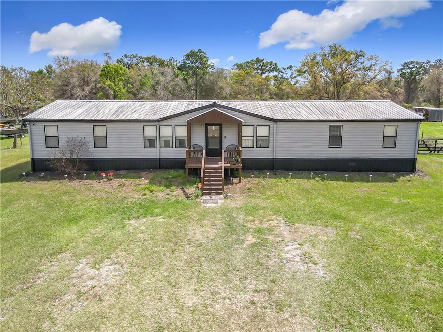 Under contract-accepting backup offers. Spacious country living with room to grow! Here is your opportunity for a spacious home with land, priced to sell. Welcome to 5165 Apollo Ave. in St. Cloud, Florida — a well-maintained manufactured home built in 1996 offering 5 bedrooms and 2 bathrooms on just under 1 acre of land with NO HOA and NO CDD. Step inside to an inviting open floor plan featuring both a comfortable living room and a separate family room complete with an electric fireplace, perfect for relaxing evenings. The 5th bedroom can make the perfect home office, gym or den. The updated kitchen showcases stainless steel appliances, solid wood cabinets and flows seamlessly into the main living areas, making entertaining easy and enjoyable. Vaulted ceilings enhance the spacious feel throughout the home. This home has been thoughtfully updated including both bathrooms, with a walk-in shower plus a tub and shower combo. Laminate flooring flows seamlessly throughout the home providing a bright and spacious feeling. Features include a metal roof, HVAC 2023, and septic system pumped in 2023. The home also features a newer whole-house filtration system and tank, adding extra value and convenience. Enjoy the practicality of your own dedicated laundry room and unwind outdoors on the rear patio, ideal for afternoon gatherings or quiet country sunsets. With plenty of space for vehicles, boats, campers or gardening this property offers flexibility and freedom rarely found at this price point. Holopaw has local restaurants, shopping and near the Community Center offering access to parks, playgrounds, baseball fields plus a second park including a basketball court. Orlando International Airport is 35 miles away and the Brevard County beaches are only 33 miles away. Don’t miss out—schedule your showing today! All information is deemed reliable and shall be independently verified. Lot lines and measurements are estimated. Buyer should perform their own due diligence.