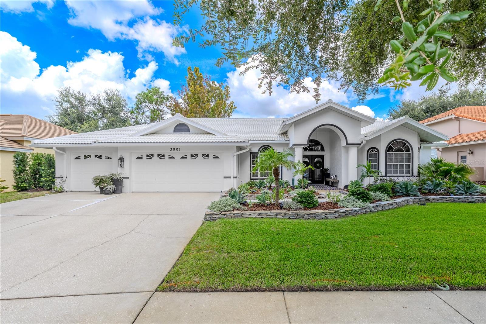 Welcome to the Reserve at Lake Tarpon, where everyday living feels like a retreat. Nestled in one of Palm Harbor’s most beautiful neighborhoods, this 3-bedroom, 2-bathroom pool home with a 3-car garage offers the perfect blend of comfort, convenience, and the outdoor Florida lifestyle. Surrounded by tree-lined streets, nearby parks, and easy access to US-19, Tampa Road, Highland Lakes Elementary, John Chesnut Sr. Park, and the Oldsmar Sports Complex, this location places you at the heart of it all. The foyer welcomes you with soaring ceilings and arched transom windows that set a bright and inviting tone. The spacious living room is filled with natural light from large windows and sliding doors overlooking the pool and lanai. Custom built-ins and dual ceiling fans create a comfortable space for relaxing or entertaining with ease. At the heart of the home, the kitchen features abundant cabinetry, double ovens, and an impressive three pantries for maximum storage. A breakfast bar seamlessly connects the kitchen to the living area, making it a natural hub for gatherings. The adjoining dining space is wrapped in windows that frame serene views of the pool and backyard, blending indoor comfort with outdoor beauty. The private primary suite is generously sized and designed to feel like a retreat. Sliding glass doors open directly to the pool area, while a walk-in closet offers excellent storage. The en-suite bathroom includes dual vanities, a soaking tub framed by arched windows, a walk-in shower, and a private water closet—perfect for unwinding at the end of the day. A versatile office or den is located just off the living room, offering flexibility for work, study, or hobbies. The oversized laundry room includes cabinetry, shelving, and a utility sink, while the split-bedroom layout provides privacy with two additional bedrooms and a full bathroom featuring dual sinks and a tub/shower combination. The attic offers even more storage options with two pull-down ladders. Step outside and enjoy the best of Florida living in your private backyard retreat. The screened lanai includes a sparkling pool, covered patio for alfresco dining, and generous deck space for lounging. Mature landscaping enhances the peaceful setting, creating an ideal spot for year-round enjoyment, and an irrigation well ensures the landscaping remains Recent updates provide both value and peace of mind, including a new A/C (2022) with a 10-year warranty, hot water heater (2021), and water softener (2023). Additionally, the pool frame was painted, rescreened, and all new hardware (including a new door) installed in 2025. With solid bones, a thoughtful split floor plan, and ample storage throughout, this home offers both comfort today and the opportunity to personalize with your own style. Located just minutes from the beaches at Honeymoon Island and Tarpon Springs, this home places you near endless opportunities for boating, fishing, hiking, and enjoying Florida’s natural beauty. Shopping, dining, and commuter routes are all within easy reach, making this property the ideal combination of lifestyle and convenience. Don't miss out on this one-of-a-kind opportunity! Schedule your personal tour today before another savvy buyer scoops up this beautiful home.