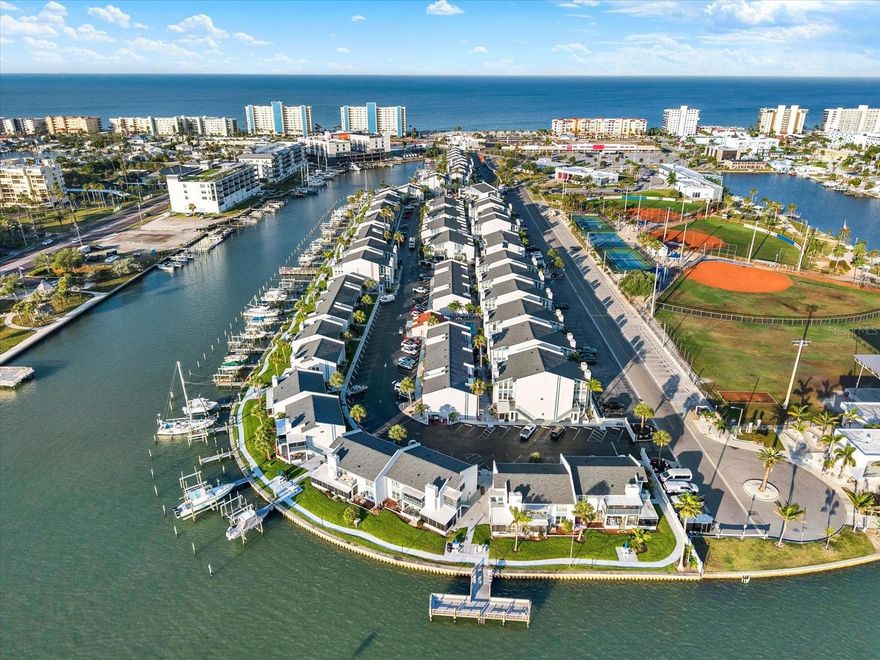One or more photo(s) has been virtually staged. Discover Paradise in Madeira Beach: Fully Renovated GROUND FLOOR Condo with Gulf Vibes and Investment Potential! Madeira Beach Yacht Club offers 7 DAY RENTALS. Welcome to your slice of Florida bliss in this stunning, completely renovated ground floor condo in the heart of Madeira Beach. Meticulously updated in 2026 with modern finishes and thoughtful design, this 2BR/2BA (master en-suite) gem offers the perfect blend of coastal luxury and everyday convenience—ideal for full-time residents, snowbirds, or savvy investors seeking strong rental income from vacationers drawn to the area's pristine beaches and vibrant scene. Step inside to an open-concept living area that flows seamlessly for effortless entertaining or relaxed family time. The spacious layout features a bright, airy great room with laminate flooring, ceiling fan, 5" baseboard and with the guest bathroom, featuring QUARTZ COUNTERTOPS and bedrooms tucked off a private hallway for optimal privacy and peace. The heart of the home is a large, gourmet kitchen boasting BRAND NEW QUARTZ COUNTERTOPS with ample space, SHAKER CABINETS, BRAND NEW STAINLESS STEEL APPLIANCES, and storage that's perfect for whipping up beachside feasts or hosting guests. Unwind in style with not one, but TWO LARGE SCREENED IN LANAI'S, one being a FLORIDA ROOM, each featuring ceiling fans—your personal oasis for savoring morning coffee, evening sunsets, or al fresco dining without the bugs.  In 2026, the front lanai frame and screens were replaced.  Grill provided for those home cooked land and sea grill nights!  And for those pool days? You're just steps away from one of two community pools, yet thoughtfully positioned away from it to ensure zero noise disruption—pure tranquility awaits. Stackable Washer & Dryer Hook up is in the quest bedroom closet. Enjoy the rarity of two dedicated parking spots, making life easy for you and your visitors. Location is everything here—stroll just minutes to the sugar-white sands and turquoise waters of the Gulf of Mexico, or pop over to nearby grocery stores and a bustling shopping strip for all your essentials. Directly across the street lies ROC Park, a community treasure offering endless recreation: baseball fields and batting cages for sports enthusiasts, tennis/pickleball courts and basketball hoops for friendly matches, a refreshing water splash pad, dog park, fishing pier and an amphitheater hosting concerts, festivals, and seasonal events that bring the neighborhood to life year-round. Additionally, the shops and entertainment at JOHN'S PASS is also within walking distance offering shopping, bars, food, jet ski rentals and fishing charters.  HOA SIRS fully funded per Florida Law and passed Milestone Inspection in 2023. There are NO special assessments scheduled. The HOA fee Includes, Building Flood Insurance (not contents), Pool Maintenance, Grounds Landscaping, Water, Trash, Internet, Basic Cable, and reserve funding. Whether you're dreaming of a forever home with that unbeatable Florida lifestyle or an income-generating vacation rental in a high-demand area with a minutes walk to the beach, this condo delivers it all. Don't miss out—schedule your private tour today and make Madeira Beach your reality!