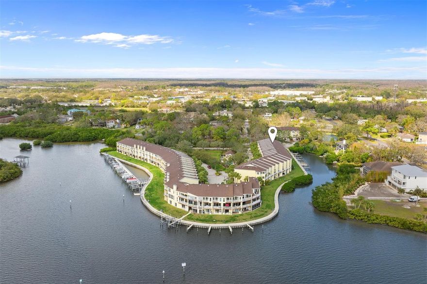 Welcome to this beautifully updated, move-in ready townhome offering private, upscale waterfront living in the gated community of Seaside Estates. Resort-style amenities include a gated pool area, tennis courts, and a kayak/canoe launch. Inside, you will find this immaculate 3-bedroom, 3-bathroom townhome radiates pride of ownership. The open-concept main floor features high ceilings, abundant natural light, and triple sliding doors with remote-controlled shades leading to a large covered balcony overlooking the water. The updated kitchen offers granite countertops, stainless steel appliances, pantry, and eat-in bar. A secondary bedroom and full bathroom with walk-in shower complete the main level. Upstairs, vaulted ceilings and skylights create an airy retreat. The primary suite includes double walk-in closets, a private covered balcony, and a luxurious bath with dual sinks, marble counters, and walk-in shower. The third bedroom features its own updated full bath with tub/shower combo. Laundry is conveniently located on the upper floor. Features and upgrades include IMPACT WINDOWS, IMPACT SLIDING GLASS DOORS, plantation shutters, luxury waterproof laminate flooring, a fire sprinkler system, newer roof (2017, HOA maintained), newer AC (2023), deeded boat slip, 3-car garage with storage, and very affordable insurance. Oldsmar is known for quality of life, top-rated schools, and a convenient location between Tampa International Airport and sparkling Gulf beaches. Schedule your private showing today – you will find it is even more impressive in person!