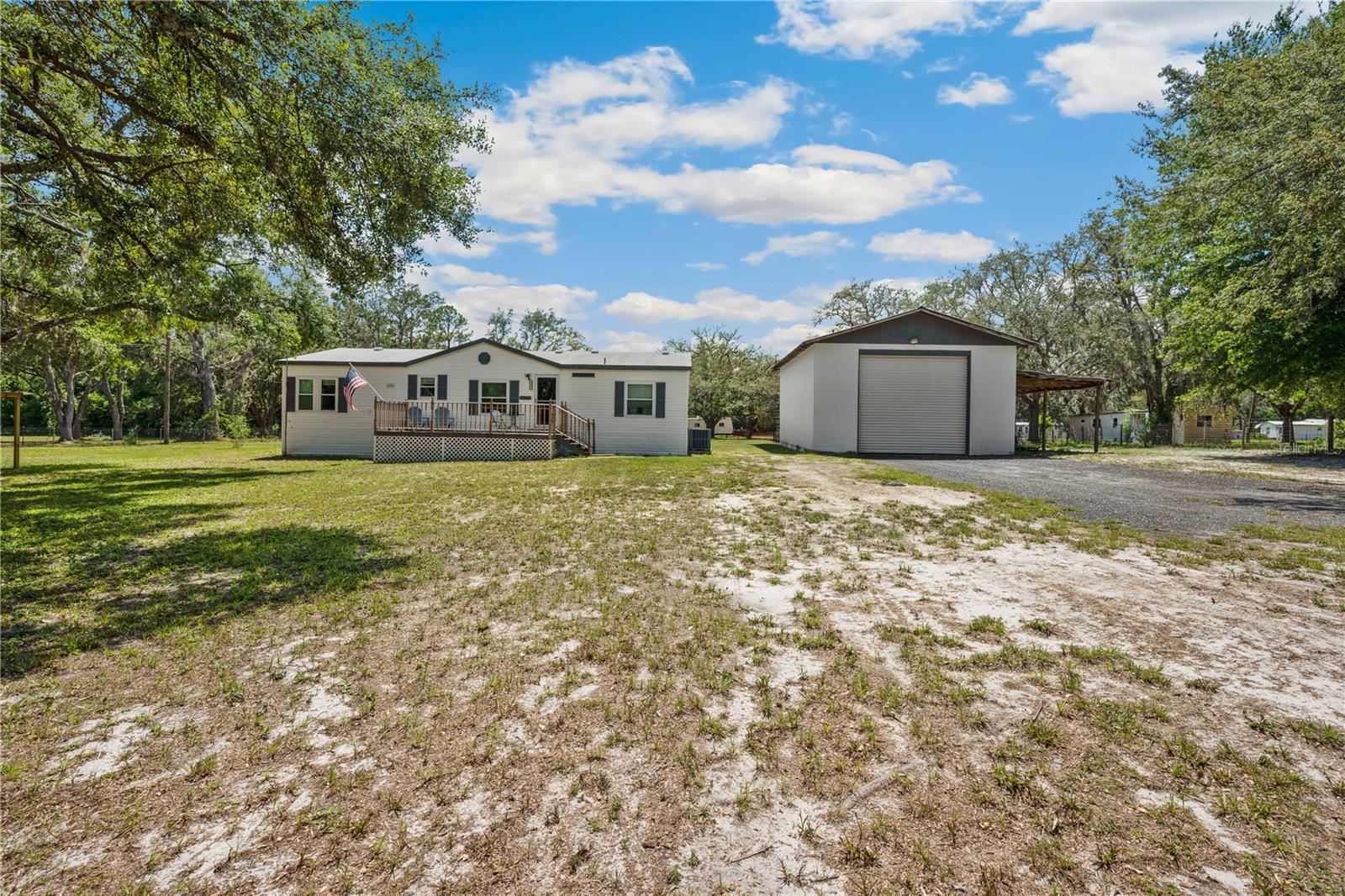 Welcome to this Private 5-Acre Retreat in the Heart of Central Florida!
If you're looking for space, peace, and the kind of charm only the countryside can offer, welcome home. Tucked away beneath a canopy of mature oak trees, this beautiful 5-acre property in Ridge Manor, Florida, offers the perfect balance of tranquility, functionality, and location.
This 1999-built 3-bedroom, 2-bathroom home spans 1,404 square feet of thoughtfully designed living space. This manufactured home offers the perfect backdrop for country living—without sacrificing comfort or convenience.
Approximately 3 acres are fully fenced and cross-fenced, ideal for animals, gardening, or creating your own little homestead. A large, detached garage provides tons of space for tools, toys, or hobbies—and with no HOA to worry about, you’re free to dream big.
Updated, inviting interior with fresh interior paint (done in 2022) and gorgeous luxury vinyl plank flooring throughout. Not to mention, the large Florida room is a true bonus!
A new roof was installed in 2021, providing peace of mind. This home is serviced by a private well and septic system.
Centrally located with easy access to three of Florida’s most vibrant cities: Orlando, Tampa, and Ocala!