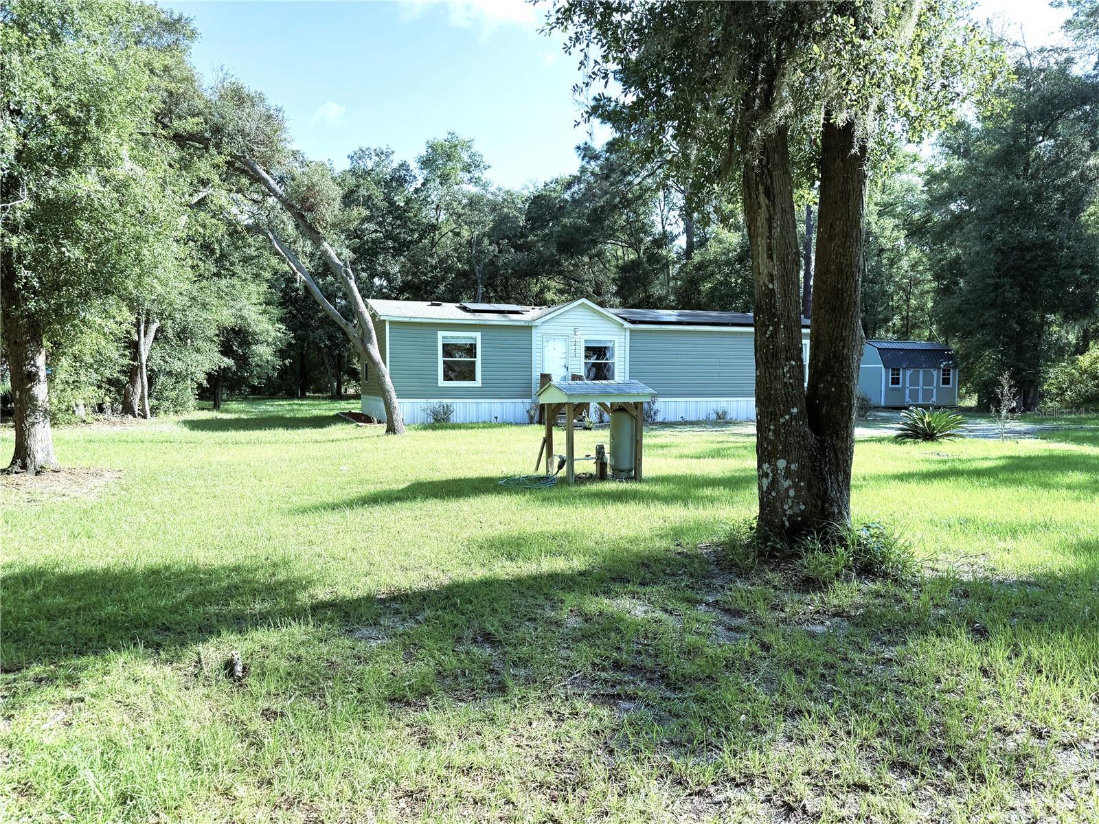 FINALLY THE FREEDOM OF 1.25 ACRES OF PEACE, SERENITY, SPACE AND COUNRTY VIEWS OF BIG SKY SUNSETS OVER FIELDS
OF GREEN. BRING YOUR RV AND WHOLE HOUSE GENERATOR. ELCTRIC WIRED IN FOR GENERATOR USE FOR RV HOOK UP.
WATER RIGHT THERE & EASY DUMP WITH SEPTIC ON WAY IN OR OUT OF PROPERTY. ELECTRIC BILL UNDER $40 FOR WHOLE
HOUSE WITH THE SOLAR PANELS FOR WHOLE HOUSE AND SEPARATE SOLAR PANEL FOR NEW SOLAR WATER HEATER.THIS
2019 3/2 1484 SQ/FT MFG'D COTTAGE STYLE HOME, IS ADORNDED WITH FARMHOUSE DECOR FROM THE OPEN KITHCEN WITH
NEW STOVE THRU LARGE 15X18FT MASTER & 8X13 ENSUITE WITH GARDEN TUB, EXTRA LARGE SHOWER WITH ROOM FOR
SIT DOWN CHAIRS OR WALKERS, DUAL VAINTIES AND SIT DOWN MAKE UP MIRROR & DRAWER SPACE. THE MORE THAN
ADEQUATE COMBO LIVING ROOM, DINING ROOM FLOWS OVER THE "FOOD PREP FAMILY GATHERING" ISLAND BAR INTO
SPACIOUS KITCHEN TRANGLE DESIGN W/ WALK-IN PANTRY. THEN INSIDE LAUNDRY HAS NEW 2025 WASHER & DRYER, THE
CHEST FREZZER CONVEYS, 2019 A/C, 2019 ROOF, 2019 LAMINATE FLOORS THRU OUT. GUEST ROOM #1-10X13.0 & #2 12X12.
REAR COVERED COUNTRY SITTIN' PORCH. 2019 INSULATED DOUBLE PANE & DOUBLE HUNG WINDOWS THROUGHOUT. 10X28
DOUBLE LOFTED SHED W/ FRENCH DOORS ENTRY & SPECIAL DOGGIE DOOR, THIS BLDG. SITS TO REAR OF PROPERTY HAS
ELECTRIC AND 2019 WATER HEATER CAN BE HOOKED TO WELL. 10X16 LOCKING TOOL & GARDEN TOOL SHED, SITS TO EAST
OF HOME. BOTH HAVE UPGRADED ROOFS. THIS HAS GOT IT ALL: EXCEPT "YOUR NAME ON THE DEED"..KAYAKING,TUBING,SWIMMING AND BOATING UNDER 30 MINUTES TO THE CRYSTAL CLEAR WATER OF RAINBOW RIVER STATE PARK. MANY MILE OF WALKING AN BIKING TRAILS ALL OVER MARION & CITRUS COUNTIES. MINUTES FROM SHOPPING, ENTERTANIMENT, MALLS. DR'S OFFICES, MEDICAL SPECIALIST OFFICES AND 3 HOSPITALS IN OCALA MINUTES AWAY.