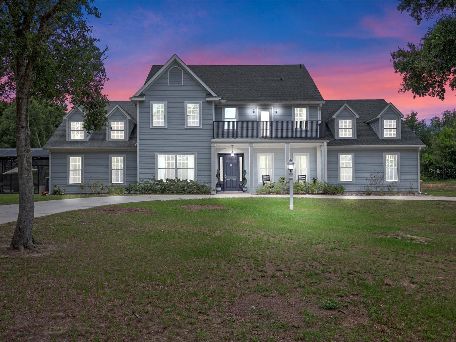 Absolutely stunning and truly one-of-a-kind, this expansive estate in the highly sought-after Sugarloaf Mountain area offers over 5,536 square feet of thoughtfully designed living space, all set on 4.32 wooded, high-and-dry acres with no HOA. Featuring 6 oversized bedrooms, 5.5 baths, this home is ideal for multigenerational living or anyone seeking luxury, privacy, and space to spread out. Formal dining and living rooms provide an elegant entertaining space. Real maple wood floors expand throughout the entire downstairs, as well as crown molding, high baseboards, and upgraded wood trim and stairwell finishes throughout. The kitchen is a chef’s dream, featuring quartz countertops, double ovens, a flat cooktop, a center island, updated cabinetry, and a large custom pantry with ample storage. The kitchen flows seamlessly into a spacious, oversized breakfast nook and family room anchored by a wood-burning fireplace. The main floor primary suite is a private retreat, offering separate his-and-her bath areas for maximum privacy, a large walk-in shower and separate soaking tub, dual walk-in closets, and French doors leading to the pool. Upstairs, you'll find four additional oversized en-suite bedrooms, and a large standard bedroom—each with large walk-in closets. Enjoy the massive media/game room equipped with blackout shades, a custom barn door, and an 85-inch movie room TV that conveys with the home. The outside is just as appealing as inside. Enjoy resort-style living with a saltwater PebbleTec pool featuring a sun shelf, 12-person hot tub, and remote-controlled screen enclosure that opens to expand the entertaining space. The large screened lanai offers both covered and open patio areas, perfect for hosting gatherings. Additional outdoor highlights include a cozy fire pit with custom gazebo swings, a custom treehouse with loft and slide, and the peace and serenity of being surrounded by trees and seclusion yet only 15 minutes away from shopping, dining and more. Other features include a private well house, 50-amp RV hookup, and storage shed. The property is partially fenced, pre-wired for EV charging, and includes a whole-house generator with a 500-gallon owned propane tank—capable of powering the home for up to two weeks. Recent upgrades include a new roof (2019), 5-year-old A/C system, E-rated windows, and attic heat barrier for energy efficiency. This extraordinary home combines luxury, comfort, and peace in a private setting just minutes from everything. A rare opportunity you won’t want to miss. *Aerial photo property lines are an estimate and to be verified by buyer.