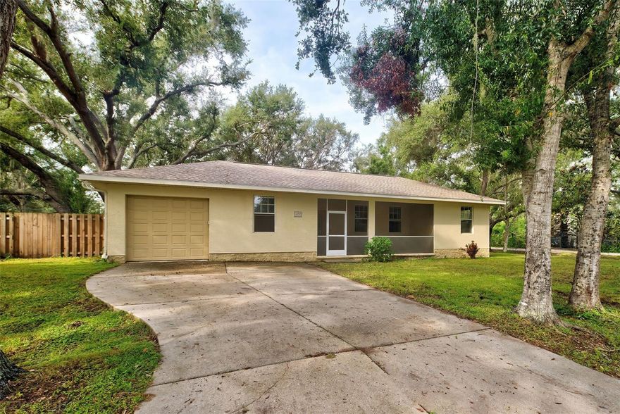 LOOKING FOR THAT "OLD FLORIDA" NEIGHBORHOOD - STOP THE CAR! This spacious VENICE 2 bedroom / 2 bathroom home has been nicely renovated with granite counters, solid wood cabinets with soft close drawers, tall 10' ceilings, tall PGT windows, washer and dryer inside. and a NEW 2023 ROOF! This LARGE corner lot is filled with lush mature oak trees, and is COMPLETELY FENCED in with a  6' WOOD FENCE, offering privacy for pets and family gatherings. The massive front porch features a shaded screened sitting area, and the back lanai features another large covered screened area to extend your outdoor living space. This large lanai is perfect dining or entertaining with access through the living room sliding doors, master bedroom and kitchen, and there's plenty of room to add a hot tub! The Master bedroom features tray ceilings, tall windows, a spacious en suite master bath with granite counter tops and access to the lanai. The guest bedroom features a unique desk nook area, and more tall windows. This home comes with hurricane shutters, new 2023 ROOF, and a newer water heater. There is NO FLOOD ZONE, NO CDD, NO DEED RESTRICTIONS, so you may park a boat or RV in driveway or along side!  This home is Perfect for the FIRST TIME HOME BUYER buyer, as this home may be purchased with an ASSUMABLE FHA loan with a super low rate! Great Venice location, close to so many restaurants, shopping, and Wellen Park and Venice Beach both only 5 miles away!  Don't delay, this home is a real charmer!