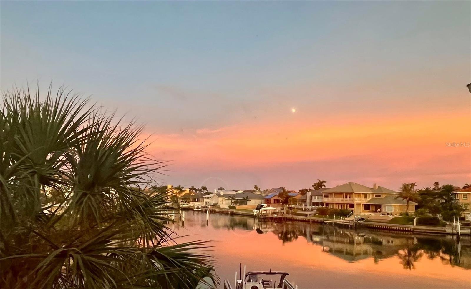 PRICE REDUCED!!! If you're seeking spacious waterfront living with a 16,000 lbs boat lift on a protected wide canal, just minutes to the open waters of Tampa Bay and the Gulf of America, this is the home for you! Enjoy plenty of room, plus the added benefit of a mother-in-law suite or in-home office space. This 3300sf beautifully updated townhome feels more like a single-family home than a townhouse. It’s nestled in a small, exclusive community on the pristine island neighborhood of Tierra Verde. Offering a total of 4 generous bedrooms, 4 full bathrooms, and 1 half bath, this home provides ample space for everyone.
As you pass through the fenced courtyard with luscious retreat feel and enter through double doors, you're greeted by a grand foyer that leads to a striking unique feature: a walk-in, temperature-controlled wine cellar that holds up to 500 bottles, perfect for wine enthusiasts.
The kitchen is a true chef's dream, featuring wood cabinetry, a central island, stainless steel upscale appliances, three ovens, new refrigerator, a beverage fridge, and an ice maker. There’s also a convenient coffee counter, perfect for your morning routine. The kitchen’s expansive layout is complemented by a side bar, which creates an ideal space for entertaining. The view of the saltwater canal sets the perfect tone for both everyday cooking and hosting guests. The kitchen seamlessly flows into the breakfast bar and opens into the spacious living room, where you'll enjoy stunning water views. The open-concept living and dining areas are perfect for large family gatherings.
The living room, with its contemporary decorated fireplace wall, leads directly onto the patio, where you can grill outdoors, keep a boat storage box, and lounge or dine while enjoying the sunrise or watching dolphins and manatees swim by. Community waterside pool is just steps away.
Upstairs, the primary suite is a true retreat, with breathtaking water views, high ceilings, and its own private balcony overlooking the canal. The luxurious en-suite bathroom features a freestanding gray tub complementing the wall panels, dual vanities, and a walk-in shower next to a large walk-in closet. Two additional guest bedrooms suites with ample closet space and full bathrooms are located on the opposite side of the floor. Laundry room is on the same level as the bedrooms.
An additional bonus area on the upper floor offers endless possibilities — perfect for an office, workout space, or extra storage, including a large attic. The spacious street side 2-car garage is underneath the large Mother in-law suite with kitchenette and living room combo, spacious bedroom with walk-in closet and full bathroom.
For added protection, hurricane shutters are installed on the waterside of the home. The property did NOT experience any flood damage during 2024 storms.
This home has been meticulously updated, with a new composite deck (2022) — the largest in the community — a newer roof (2021), new dock (2019), new motors/gears/cables (2021), updated HVAC systems (second floor, 2019; first floor, 2018), and a new water heater (2024), wine cellar( 2023). The tankless water heater and subpanel in the mother-in-law suite/apt have also been upgraded.
Located in pet friendly waterfront pool community, by walk-in and biking trail, just 10 minutes to downtown St. Petersburg, Fort De Soto Beach and dog park, and Pass-a-Grille Beach, this home offers the perfect blend of privacy and convenience.