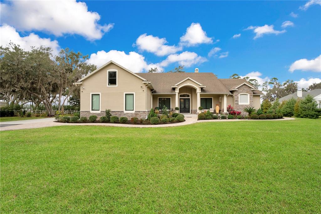 Welcome to Lake Front Living at this stunning 4 bedroom, 3 bathroom home located in St Cloud. Zuni Road is located just outside Lake Nona on a 4.97 acre lot, featuring a gated entrance, private drive way and Hindon Lake right in your backyard.
This one story home has over 2,800+ square feet featuring an open floor plan with Lake Front views, natural sunlight, high ceilings, top to bottom renovations and luxury upgrades throughout. Upgrades include a new roof, new ac, new windows, new doors, remote controlled custom blinds, accordion style patio doors, bathroom fixtures and porcelain tile floors.
Upon entering the home, the foyer opens up into the family room, additional living space, wet bar, kitchen, and breakfast nook. The stunning custom kitchen comes equipped with high-end Viking appliances, an oversized marble island and accordion style patio doors that open onto the screened-in lanai and oversized backyard.
The laundry room, additional bedrooms and guest bathroom are on the left side of the split floorplan and the Master Suite is located to the right. The Master Suite offers his and her walk-in closets and vanities, a stunning walk-in shower, and soaking tub with a fireplace. The bedroom also patio doors that open to the Lake Front View, making every evening a sunset evening to enjoy inside or out.