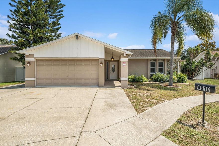 One or more photo(s) has been virtually staged. Welcome to your Florida oasis! This beautifully remodeled 2-bedroom, 2-bath, 2-car garage home is tucked away on a quiet cul-de-sac in the desirable Orchid Lake community. Inside, you’ll find easy-maintenance wood-look ceramic tile flooring, vaulted ceilings, and an open split-bedroom floor plan filled with natural light. The updated kitchen features granite counters, stainless steel appliances, and a center island with a breakfast bar—perfect for entertaining. The spacious Great Room opens through sliders to a screened lanai and fully fenced backyard, offering plenty of room for a pool. Both bathrooms have been tastefully remodeled, and the large garage with an extra cement pad provides bonus parking for a boat or guests. Conveniently located near shopping, dining, golf, and Sims Park, with easy access to Gulf Coast beaches, Downtown New Port Richey, and just 45 minutes to Tampa International Airport. With no HOA, NO CDD, and NO Flood Insurance Required, this move-in-ready home captures the best of Florida living!