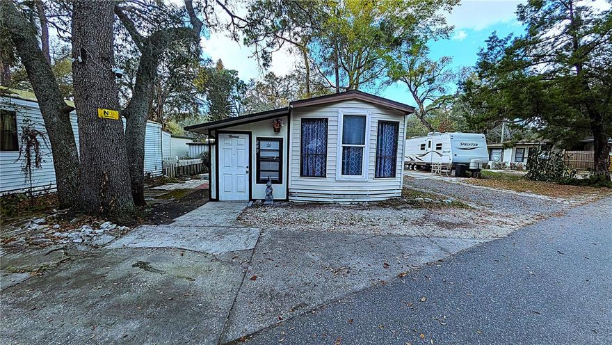 Located in the gated community of Clarcona Resort / Jellystone Park in Apopka, this 1-bedroom, 1-bath manufactured home features an expanded layout with two versatile bonus rooms, offering flexible space for a home office, hobby area, or guest use.

The property includes a storage shed and a dedicated two-car parking area, providing practical outdoor functionality. Set among mature Florida landscaping, the setting offers a quiet and established environment.

Ownership includes the land, adding long-term value and flexibility. Monthly HOA dues cover water, sewer, and trash, along with access to community amenities such as a swimming pool, clubhouse, playground, and mini golf.

The community offers controlled access and is conveniently located near major roadways, including the 414, with easy access to shopping and dining in the Apopka area.

A great option for a primary residence, seasonal use, or investment opportunity.

Buyer and buyer’s agent to verify all information, measurements, restrictions, and community details.