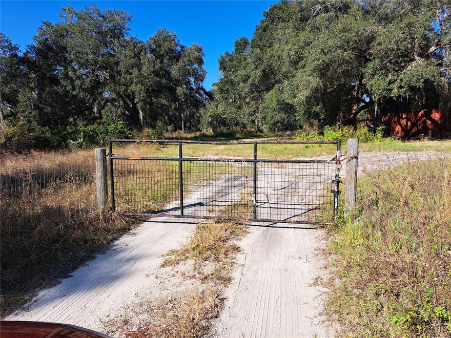 Beautiful wire fenced and gated acerage located within 2 miles of The Villages on a paved road, zoned agriculture.