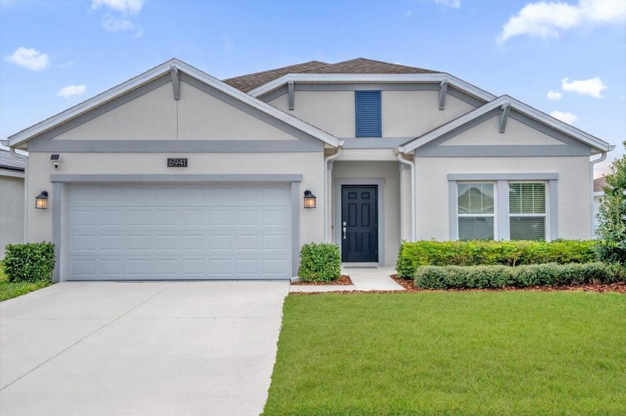 Discover refined Florida living in the highly sought-after, resort-inspired community of Trinity Lakes—where luxury, convenience, and lifestyle seamlessly converge, all with the added benefit of a low HOA. This impeccably upgraded 4-bedroom, 2-bathroom residence is ideally suited for discerning buyers, whether relocating to Central Florida or Florida residents seeking a vibrant new community to call home.

Designed with an expansive open-concept layout, the home is filled with natural light, creating an atmosphere that is both sophisticated and welcoming. The effortless flow between the living, dining, and kitchen spaces makes it ideal for elegant entertaining and everyday comfort. At the heart of the home, a dramatic dual-sided fireplace connects the main living area and the private primary suite, delivering warmth, ambiance, and architectural distinction rarely found at this level.

The home is thoughtfully equipped with solar panels, smart home technology, and energy-efficient systems, offering modern luxury paired with long-term cost savings. A whole-home water softener system enhances daily living, while professionally installed gutters ensure ease of maintenance and lasting peace of mind.

Step outside to a fully fenced backyard retreat, designed for privacy and outdoor enjoyment. Pet owners will appreciate the built-in dog door, while a private rear access gate provides direct access to additional green space and convenient overflow parking—an exceptional feature that enhances both functionality and lifestyle.

Residents of Trinity Lakes enjoy an impressive suite of resort-style amenities, including a luxury clubhouse, state-of-the-art fitness center, playgrounds, and a scenic lakefront park with dock access—all maintained with the advantage of a low HOA, making elevated living both attainable and cost-efficient.

Ideally located just 35 minutes from Orlando International Airport with quick access to the Florida Turnpike and Highway 50, this home offers effortless connectivity to Clermont, Minneola, and Orlando. Surrounded by celebrated destinations such as Lake Louisa State Park, Green Valley Country Club, Lake David Park, and Lakeridge Winery, the location delivers an exceptional balance of recreation, convenience, and tranquility.

Whether you are relocating or simply ready to elevate your Florida lifestyle, this home offers immediate comfort, modern sophistication, a strong sense of community, and outstanding value.
Schedule your private showing today and experience everything Trinity Lakes has to offer.