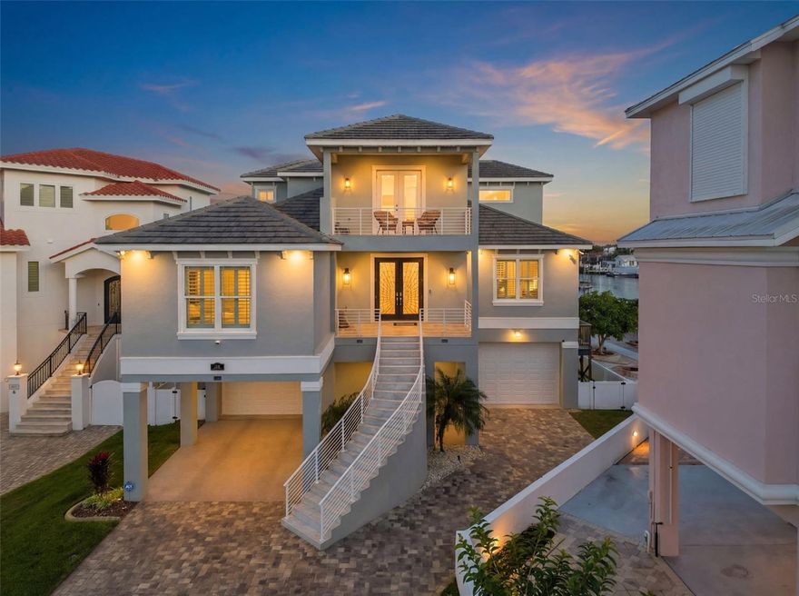 WATERFRONT luxury at its finest. This custom-built, three-story residence showcases breathtaking sunrise and sunset views over a WIDE, DEEP-WATER CANAL WITH DIRECT GULF ACCESS, offering an exceptional blend of elegance, privacy, and coastal sophistication.
 This beautifully designed home features four bedrooms plus an office/den and bonus room, a THREE-FLOOR ELEVATOR, and thoughtfully curated indoor–outdoor living spaces on every level. The property experienced zero storm damage from Hurricanes Helene and Milton.
 
A grand, open foyer welcomes you with immediate water views, setting the tone for the light-filled, open-concept design. The main living level showcases walls of windows, soaring ceilings, and seamless access to multiple balconies overlooking the canal, pool, and dock. The gourmet kitchen features premium cabinetry, quartz countertops, a massive island with Blue Lemurian stone, Sub-Zero appliances, gas cooking, pot filler, walk-in pantry, and custom finishes throughout.

The second floor offers two front bedrooms with a Jack-and-Jill bath, a private guest suite with balcony access, a beautifully appointed office/den with Gulf views, and a spacious laundry room. The third-floor owner’s retreat features a generous primary suite with cathedral ceilings, electric fireplace, and a serene balcony with panoramic water views. The spa-inspired primary bath includes Italian marble, steam shower, soaking tub with multicolor lighting, dual vanities, and an oversized custom walk-in closet filled with natural light. An additional sitting room or bonus space opens to a front balcony showcasing sunset views over the Gulf.

Outdoor living is exceptional with multiple balconies on each level, a SALTWATER POOL WITH PEBBLE TECH FINISH, fire pit, pavered lanai and deck, and a 75’ DOCK WITH FLOATING DOCK, WATER, AND 50-AMP ELECTRIC SERVICE—ideal for boating enthusiasts. The deep-water canal offers NO TIDE RESTRICTIONS and quick access to Anclote Island and sandbars.

Additional highlights include HURRICANE IMPACT WINDOWS AND DOORS, plantation shutters, epoxy-sealed balconies, cedar ceilings, generator transfer switch, propane system, two Carrier AC systems, spray foam insulation, a large multi-car garage, extended driveway parking, and TRANSFERABLE LOW-PRICE FLOOD INSURANCE. Located in a golf-cart-friendly waterfront community featuring a private sand beach, three separate private community boat ramps, yacht club access, and a civic center.

A rare opportunity to own a luxury Gulf-access home offering remarkable views, quality construction, and an exceptional coastal lifestyle.