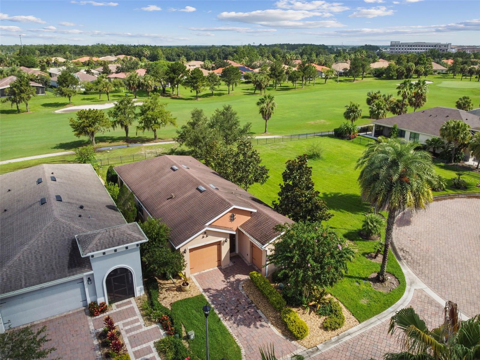 LOCATION! This stunning Bergamo model home sits just steps from the Village Center amenities and boasts a beautiful golf course view. Featuring 2 bedrooms, 2 bathrooms, a den/study, and a coveted golf cart garage, this home was originally built as a model, packed with upgrades, and not lived in until 2021! The open-concept layout connects the dining area and great room, offering clear sight lines through the lanai to the lush golf course beyond. The gourmet kitchen is equipped with granite counters, solid wood cabinetry, and an eat-at bar, perfect for both casual meals and entertaining. The spacious primary suite features serene golf course views, an extra-large walk-in closet, dual vanities, and a large shower with built-in seating. The guest bedroom is conveniently located next to the full guest bath, while the den/study includes custom cabinetry with granite counters and a built-in wine cooler. Additional highlights include a whole-house water filtration system and the sought-after golf cart garage. This home offers the perfect blend of luxury, functionality, and location! Solivita is renowned for its vibrant 55+ community, offering an array of activities and amenities tailored to active adults. Whether you’re enjoying a round of golf, engaging in fitness classes, or simply strolling along scenic walking paths, this neighborhood promotes an active and fulfilling lifestyle with over 230 clubs, sports, and activities to choose from. Enjoy the community’s clubhouse, softball field, 14 swimming pools, an indoor walking track and indoor pool, and much more. Every day offers something new to explore and enjoy! This home also features easy access to nearby shops, dining, and health care, offering the perfect balance of privacy and lifestyle.Don't miss out! Schedule your private showing today!