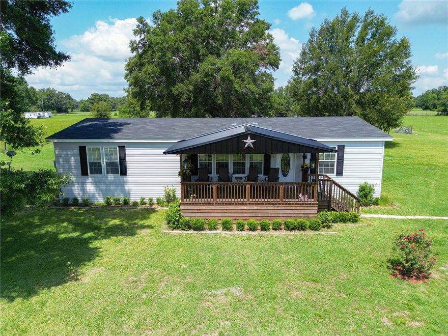 We interrupt your holiday festivities to bring you this beauty. It is hot outside but this listing is hotter. Built by Ocala Custom Homes and less than 3 years old make sure to check this out if you are in the market for a new home with a little land to call your own. This Tupelo model Jacobsen Manufactured Home boasts 1717 square feet of living space. With a huge front AND rear covered porch. 3 bedrooms. 2 bathrooms. Totally OPEN, split-floor plan with a massive center island and 532 square feet of living, dining and kitchen area. All appliances are less than 3 years old. Waterproof and durable Barnwood Luxury vinyl plank floor throughout the whole home. Situated on a paved road, in the wonderful town of Webster. On 1.72 acres. No deed restrictions. No HOA. You want chickens. You got it. A baby pig. Sure thing. There is also a 3 bay garage with workshop on-site. By appointment only but very easy to show. Open and available 7 days a week. Call today.
