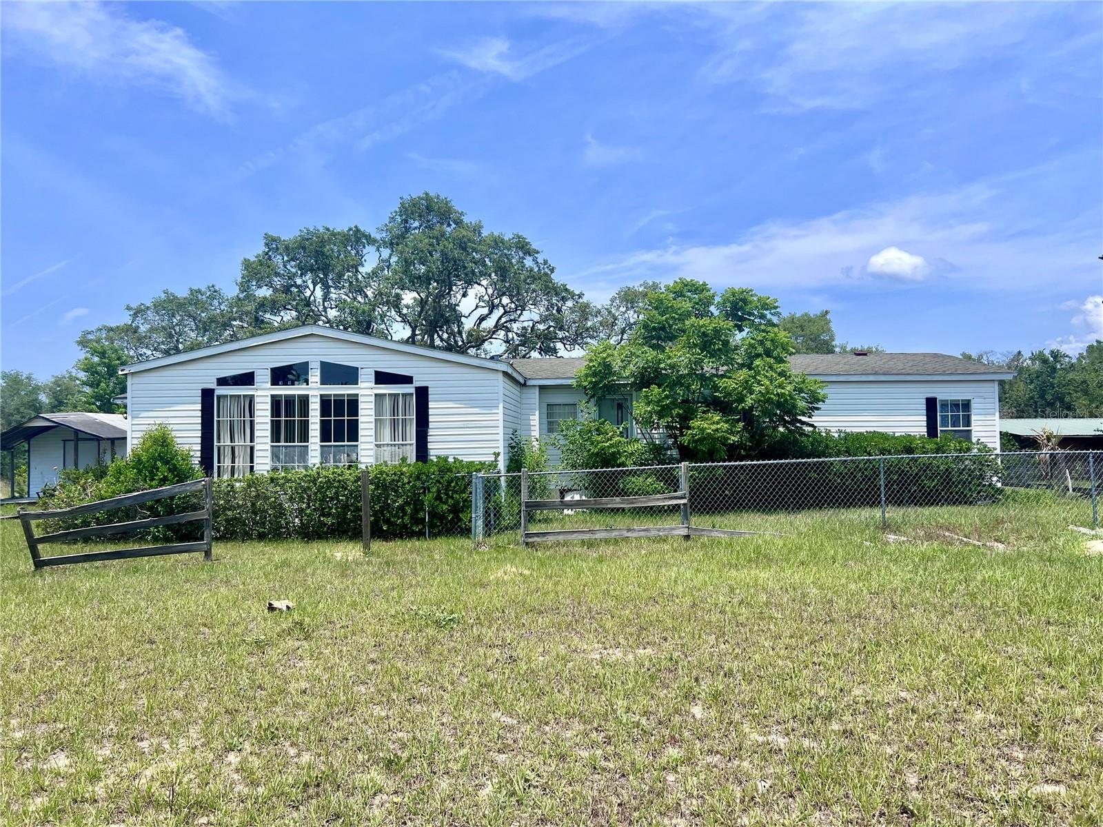 Welcome to your private agricultural paradise at 12461 Adams St, Brooksville, FL—a rare opportunity to own 4.8 fully fenced acres in one of Hernando County’s most scenic equestrian corridors. This property features a spacious 2002 sq ft triple-wide manufactured home (1993), and an 8-stall center-aisle horse barn, making it ideal for horse lovers, hobby farmers, or investors looking to unlock serious potential. The land is zoned agricultural, with plenty of room for grazing, expansion, or future enhancements. With an estimated after-renovation value of $400,000+, this is a value-packed opportunity for anyone looking to build equity quickly in a rising market.
The location offers the best of both worlds—peaceful country living with quick access to Downtown Brooksville, the Suncoast Parkway, and the natural beauty of Weeki Wachee Springs. Commuters will appreciate the easy drive into the Tampa Bay area, while outdoor enthusiasts will love the open skies and freedom this property offers. Whether you're dreaming of a personal ranch, a training facility, or simply a quiet retreat with land to roam, this Brooksville gem is ready to deliver. Don’t miss out on this one-of-a-kind equestrian property with incredible upside and endless potential.