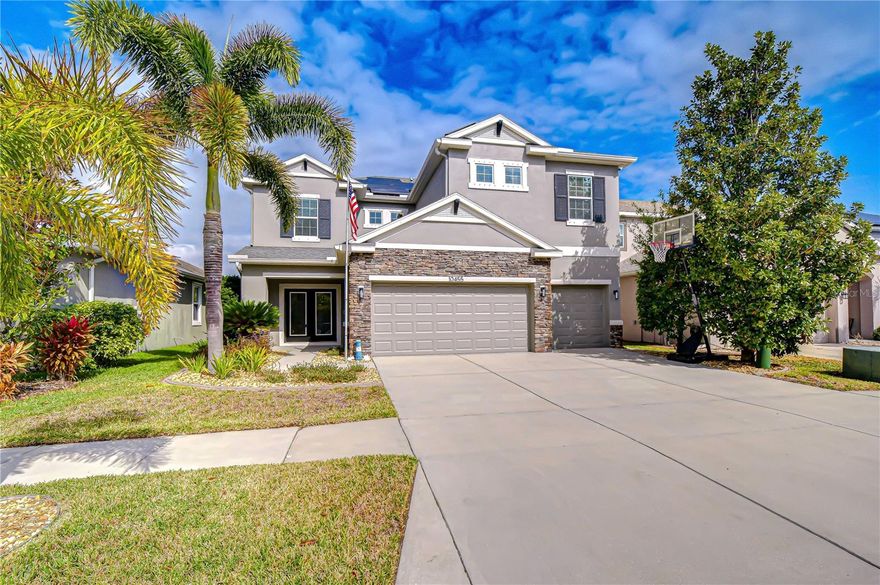 Welcome to a home that truly has it all—nestled in a quiet neighborhood and tucked toward the back of the community where peace and privacy surround you. You would never know that Interstate 75 and U.S. Route 301 are just minutes away, offering easy access while preserving a serene setting. From the moment you arrive, the curb appeal impresses. Lush tropical landscaping, stacked stone accents, and elegant glass French doors with iron inlay create a warm and sophisticated welcome. Inside, a beautifully designed and flexible floor plan unfolds. Multiple living areas offer endless possibilities—formal living, music room, reading retreat, or dining space—easily adapting to your lifestyle. The kitchen is the heart of the home, featuring 42” cabinetry with crown molding, stainless steel appliances, a prep island, and stunning quartz countertops. It flows seamlessly into the spacious family room, both overlooking the backyard oasis—perfect for everyday living and entertaining. Downstairs offers a generously sized bedroom with French doors and a large walk-in closet, ideal for guests, multi-generational living, or a private home office. A nearby half bath adds convenience. Upstairs is where this home truly stands apart. It is rare to find TWO substantial bonus spaces, and this home delivers. One expansive bonus room spans over 400 square feet—ideal for a media room, game room, home gym, teen retreat, or second living area. A separate loft provides even more flexibility for work, study, or relaxation. The primary suite features updated wood flooring, a private en-suite bath, and a generous walk-in closet. Two additional large bedrooms and a full bath complete the upper level. Step outside to your private tropical retreat with a sports-style heated and cooled saltwater pool featuring adjustable temperature settings for year-round enjoyment. The cooling feature is an incredible bonus during the warm summer months, keeping the water refreshingly comfortable even on the hottest Florida days. Complete with an outdoor kitchen, gazebo, and lush landscaping that provides exceptional privacy, this outdoor space is designed for both relaxation and effortless entertaining in every season. Thoughtful upgrades enhance both comfort and efficiency, including solar panels, a transfer switch, two electric vehicle chargers, brand new carpet, fresh interior paint, abundant storage, and an epoxy-finished garage with overhead storage. Enjoy being within walking distance to Lowe’s, Chipotle, Dutch Bros Coffee, Starbucks, medical centers, and Kids Community College Charter School. This is more than a home—it’s a lifestyle defined by flexibility, rare bonus spaces, upgrades, privacy, and unbeatable convenience.