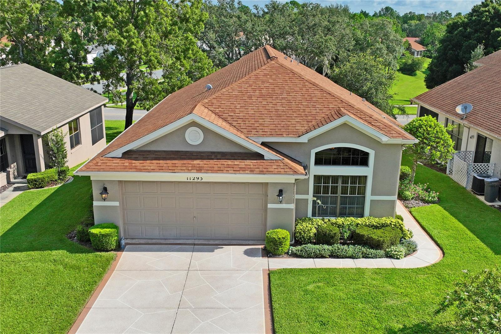 Welcome home to this spacious home located in the desirable 55+ community of Wellington at Seven Hills in Spring Hill. Beautifully maintained, this home features the Heron model floor plan by Ryland Homes that includes vaulted ceilings throughout the home, a spacious, open concept living area, kitchen with breakfast nook, as well as a large dining room. The large kitchen has beautiful wood cabinets incl. pull-outs and soft close drawers, granite countertops, breakfast bar, and a cabinet pantry as well as closet pantry. Plus, all appliances were just replaced in 2024 with stylish slate-colored appliances! Chair rails enhance the aesthetic of the adjacent breakfast area. Kitchen opens to living area - a great layout for daily living and entertaining! Main bedroom suite includes a walk-in closet, double vanity with granite counter, relaxing garden tub and separate walk-in shower with large shower seat. Two additional bedrooms are located on the opposite side of the home, both with good-size closets. One of these bedrooms has double pocket doors offering additional functionality as den, study, or hobby room. For easy maintenance, flooring in all living areas is luxury vinyl plank or laminate wood - no carpets - bathrooms are tiled. Laundry room has a laundry sink and lots of hanging cabinets for extra storage. Glass sliders lead to the screened and covered lanai offering a comfortable outdoor spot to enjoy morning coffee or just relax. Recent upgrades include resurfaced driveway (2023), waterheater (2024), luxury vinyl plank flooring in all living areas (2023), screen doors at front entry, newer paint in living area, window tint in living room, breakfast nook, and foyer transom window. Roof was replaced in 2015 and HVAC in 2019. The Wellington at Seven Hills is a gated 55+ community, centrally located with easy access to shopping, dining, medical services and hospitals, and major roadways including Suncoast Parkway for easy commute to Tampa and international airport. Community amenities include a beautiful club house with restaurant, Olympic-size pool, fitness room, meeting and computer rooms, tennis and pickle ball, and more. Nearby, enjoy the local attractions including Weeki Wachee State Park with its world famous Mermaids, Pine Island beach area, fishing piers, numerous boat ramps and kayak launch areas or take a short drive to Homosassa Springs State Park or visit Brooksville for many other activities and festivals throughout the year.