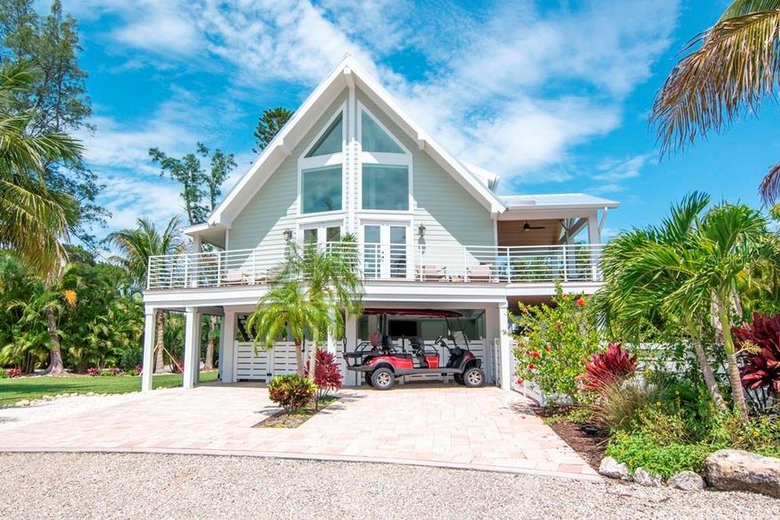 Located on the North end of Anna Maria is this 3 bedroom, 3.5 bathroom spacious, contemporary home. Completely remodeled by Gagne Construction in 2017 and sits on a large corner lot (2/10 of an acre) and quiet cul-de-sac. Mature landscaping allows ample privacy on all sides of the home, dawned with lush palms and HUGE YARD. The interior welcomes you with a gorgeous 2 story living room with soaring windows and endless natural light in the main floor open floor plan with an additional loft where you can enjoy the sunset. The main level has a big kitchen w/ quartz countertops and plenty of storage, 2 living areas and a large dining room. All bedrooms offer en-suite baths; two of them have dual sinks so the master bedroom can either be on the main level or upstairs. This house was built with entertaining in mind. There are expansive decks off the main living area plus a large covered patio just off the pool set up as an outdoor living room for outdoor entertaining. The gorgeous heated custom pool and spa add to the charm of this island home. This property can be rented by the week but has never been a vacation rental and comes fully furnished with a golf cart so that you can start using your investment right away. Additional features include upstairs laundry, ground floor storage rooms for all of your beach supplies w/ an extra fridge, plenty of off-street parking, hurricane impact windows, metal roof, elevated property, full fenced pool area. There are also plans to add a 1000 sqft addition.