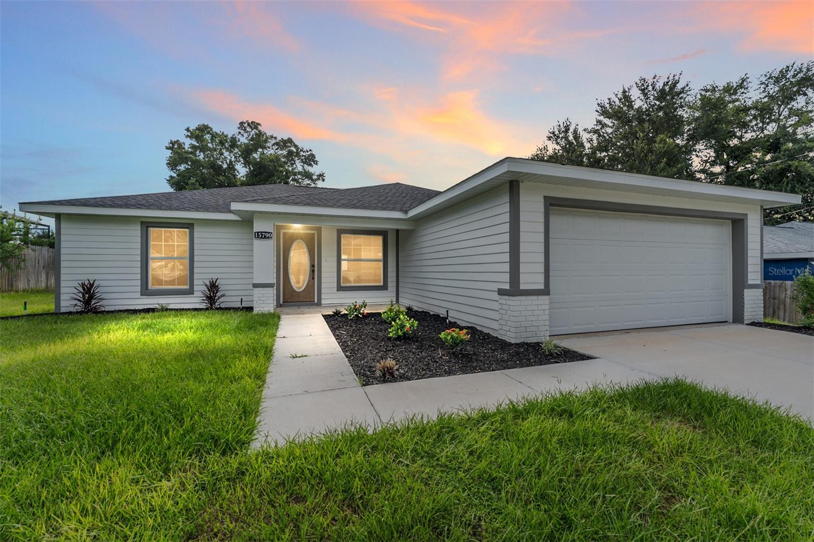 One or more photo(s) has been virtually staged. Welcome to your modern farmhouse retreat in Orange Blossom Hills!
Just minutes from The Villages and a short drive to Ocala, this 2023 custom-built 3-bedroom, 2-bath block and stucco home brings together timeless charm and today’s most desired finishes—with no HOA and no deed restrictions. That’s right—freedom, function, and fabulous style all in one.
Step inside to find luxury vinyl plank floors, tray and vaulted ceilings, 5" baseboards, and a thoughtfully designed open-concept layout perfect for both quiet nights and entertaining friends. The heart of the home—your chef’s kitchen—offers granite countertops, soft-close shaker cabinets, and stainless steel appliances that make cooking feel like a treat.
The spacious primary suite is your personal sanctuary with a walk-in closet, tray ceiling, and a spa-like bath featuring dual sinks, modern finishes, and a seamless glass walk-in shower. The two guest bedrooms are generously sized and share a beautifully appointed full bath with a nearby linen closet for extra storage.
Additional perks? Irrigation system, whole-house security system, inside laundry room, and a two-car garage. The backyard is just waiting for your personal touch—whether it’s a garden, firepit, or a future pool.
From farmhouse curb appeal to unbeatable location—this one is a must-see