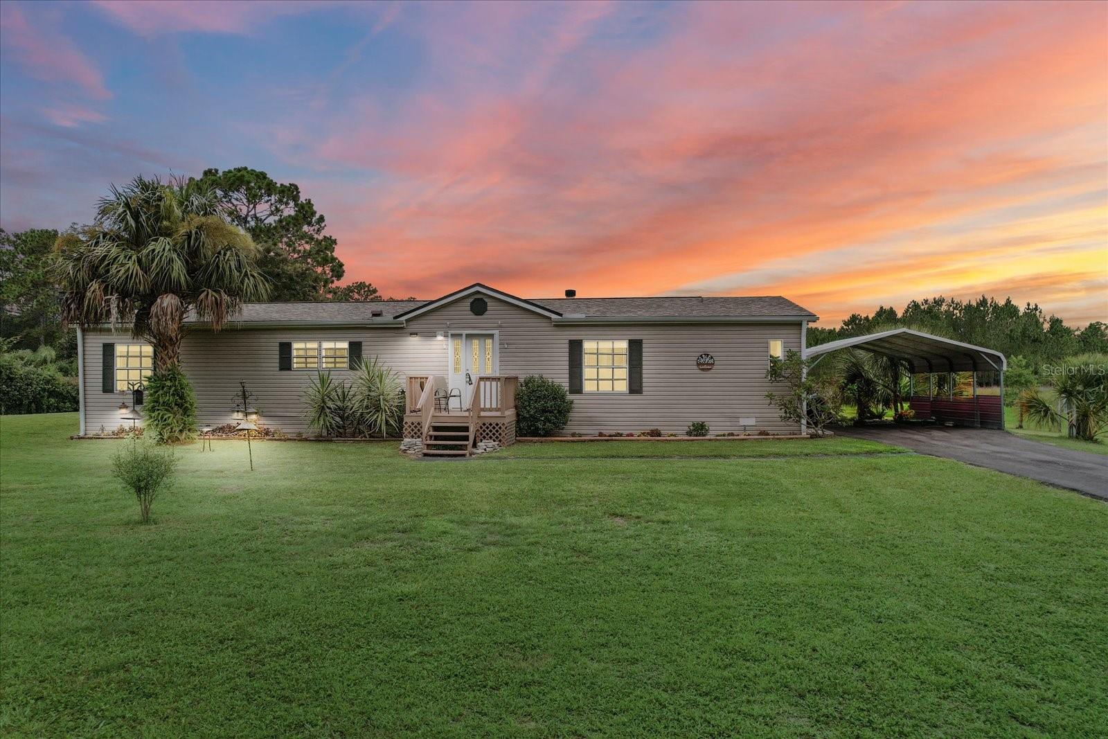 If you're on the hunt for privacy & space, with the most incredible backyard views, your search stops here! Situated on just shy of 2 acres, this property backs up to almost 34 acres of County owned property. The sunsets here are stunning! Inside features 3 bedrooms plus an ideal office or flex space, 2 bathrooms, wood burning fireplace, both split & open floor plans, interior laundry room, updated kitchen with dark stainless steel LG appliances (2024) & new flooring. Beat the heat in the 27 foot above ground pool out back. Have peace of mind with the double layered roof w/ 50 yr warranty (2021), new heavy duty septic pump and electric alarm unit, and new 3 ton AC unit (2022). Additional storage/workshop with the 36x24 Multi-purpose building (previously a portable classroom) that is equipped with electric & wall unit AC. Fully fenced and gated, with NO HOA or deed restrictions, so bring your toys! Call today to schedule your showing!