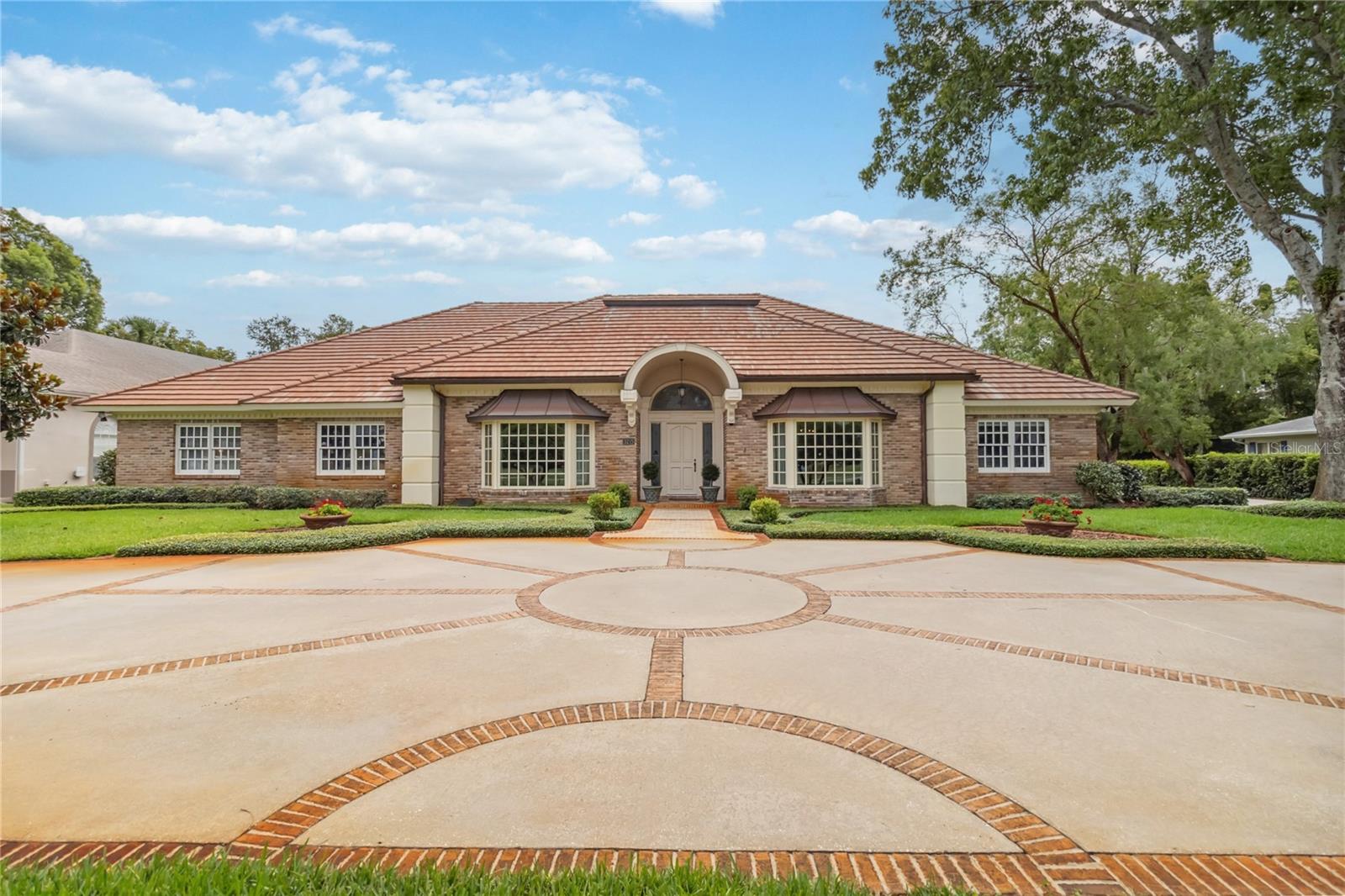 "Bundled service pricing available for buyers. Connect with the listing agent for details." This property qualifies for a preferred lender incentive. Estate-style living at its finest! This exceptional home sits on an impressive 0.72-acre lot and offers a direct front-door view of the 16th hole at the renowned Dubsdread Golf Course. Located on a dead-end semi-private road, it features a side-loaded three-car garage and a circular front drive, providing both elegance and privacy. Upon entry, you are welcomed into a grand foyer with a formal dining room to your right and a formal living room to your left. The heart of the home is the expansive family room centered around a gas fireplace, perfect for gatherings and relaxation.
The oversized kitchen is a chef’s dream, offering gas cooking, dual ovens, abundant counter and cabinet space, a built-in desk station, and both a dinette and breakfast bar. Every room in this home is generously sized, including the four bedrooms, three and a half bathrooms, and a private den or office. Please review the actual room sizes, they can not be beat. The true highlight of the property is the outdoor living space—a massive covered lanai with a full summer kitchen, gas firepit, and a private saltwater pool and spa, all gas-heated and surrounded by lush landscaping within a walled backyard.
Whether you’re entertaining or enjoying quiet time, this estate provides unmatched comfort, space, and luxury in a prime location. This is truly a must-see to fully appreciate! Dubsdread Golf Course is one of Central Florida’s most historic and beloved public golf courses, originally designed in 1924 and renovated to blend classic charm with modern playability. Located just minutes from downtown Orlando in the College Park neighborhood, Dubsdread offers a challenging 18-hole layout with narrow fairways, strategic bunkering, and mature oak trees that line many holes, making it a favorite among local golfers of all skill levels. After a round, players and visitors can unwind at The Tap Room at Dubsdread, a popular neighborhood restaurant known for its warm ambiance, scenic patio overlooking the course, and a menu featuring classic American fare like burgers, steaks, seafood, and an excellent brunch, this is all just steps from your front door.... All this with no HOA.