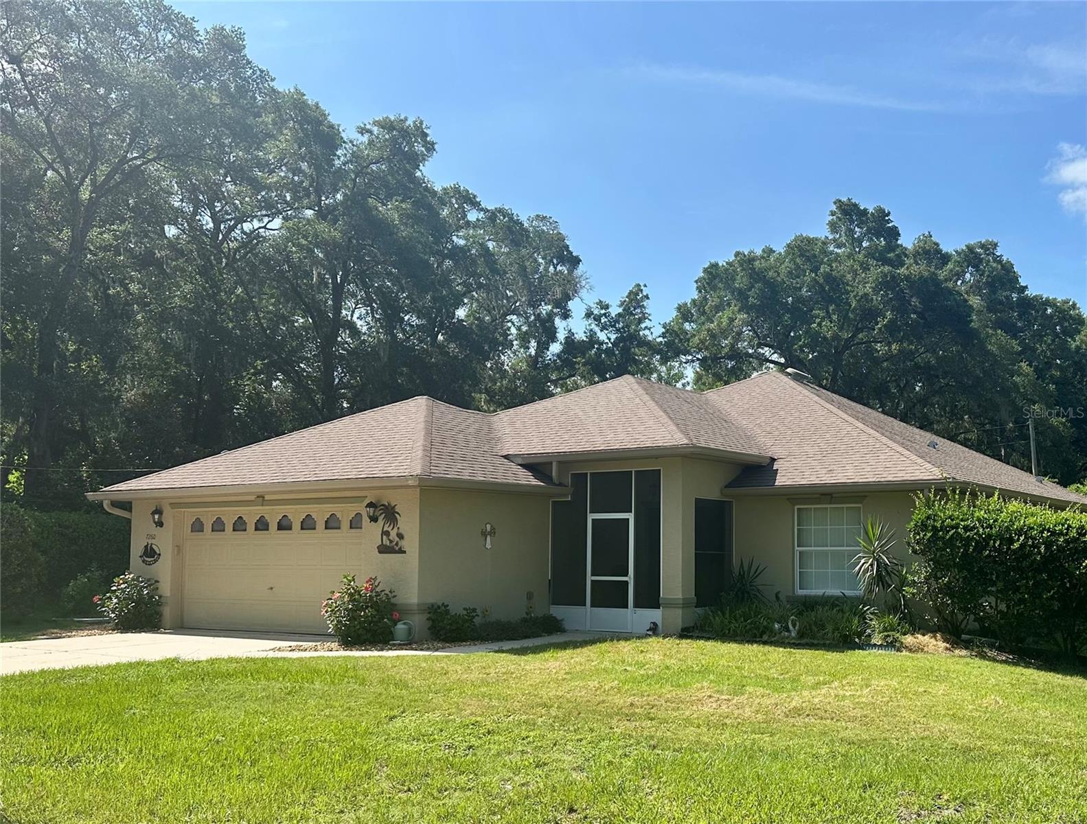 This one owner custom built home is situated in the middle of two lots with ample space for a pool, garden, or a circular drive around the back of the property leading to the storage shed with plenty of extra room for storing boats, trailers, or construction equipment. NO HOA! This split floor plan 3 Bedroom, 2 bath home is being sold fully furnished or furnishings can be removed. The open concept living, dining, kitchen and family rooms have stunning wood floors while the kitchen and baths are tiled. The family room leads to a fully screed lanai and is perfect for entertaining or enjoying nature. Newer HVAC system and dishwasher and as an added bonus, this home has an extended 2 car garage and includes a 21 X 17 metal shed ideal for extra storage and/or equipment. This home has been VERY well maintained and is conveniently located off 441/27, just minutes from some of the best restaurants, shopping and entertainment. This beautiful property wont last long and is a real MUST SEE!