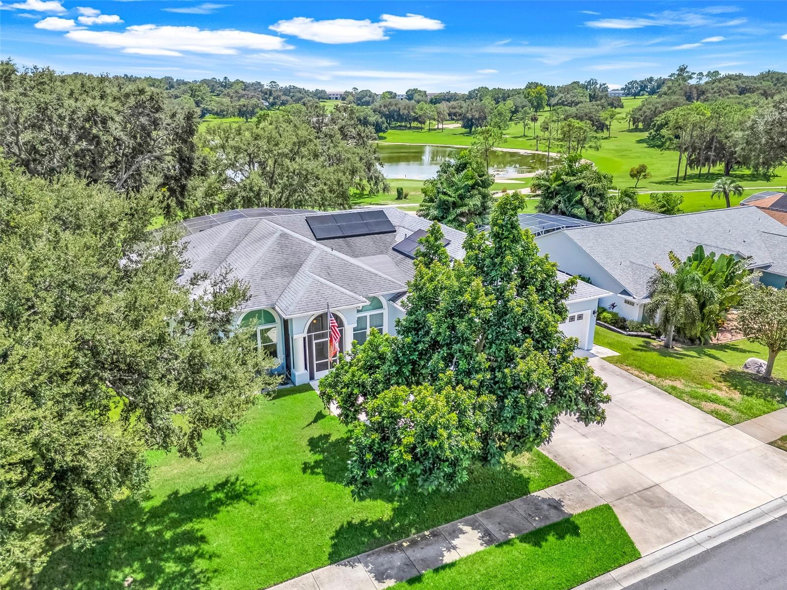 One or more photo(s) has been virtually staged. Located in the desirable Green Valley community in Clermont, this stunning 3-bedroom, 2-bath home sits on a quiet cul-de-sac and has been completely renovated from top to bottom, offering modern elegance paired with breathtaking golf course and lake views.
From the moment you step through the front door, you’re greeted with a striking open floor plan where your eyes travel straight through the living room, across the sparkling pool, and out to the serene lake and golf course beyond.
The chef’s kitchen has been fully renovated with custom cabinetry, quartz counters, stainless steel appliances, and a charming breakfast nook with a built-in storage bench overlooking the pool. Just off the kitchen, the dining room showcases a custom built-in buffet with wine cooler, adding both style and function while creating the perfect space for entertaining. The private master suite is positioned at the back of the home, designed to maximize both comfort and views. Elegant French doors lead directly to the lanai and pool area, inviting in natural light and offering a seamless indoor-outdoor lifestyle. The renovated en-suite bathroom showcases a modern shower, cabinetry, and upgraded flooring.
Both secondary bedrooms are generously sized and share a beautifully updated second bathroom that has been completely redesigned with updated walk-in shower, cabinetry, and flooring.
Step outside to your own private resort: a heated, saltwater pool anchors the expansive lanai. Designed with entertaining in mind, the outdoor area features multi-level decking with detailed brick pavers, creating plenty of space for lounging, dining, or gathering with friends and family. The covered entertaining area showcases a beautiful wood-paneled ceiling with dual fans. Completing this resort-like retreat is the fully equipped outdoor kitchen with tile countertops, built-in grill, refrigerator, bar seating, sink, and mounted TV, ensuring every occasion is unforgettable—all while overlooking the lush greens and shimmering lake.
Every major system and detail has been thoughtfully updated, including:
WHOLE HOUSE SOLAR, GENERAC WHOLE HOUSE GENERATOR, A/C UNIT 2020, WHOLE HOUSE REPIPE 2018, WINDOWS REPLACED 2018, WATER TREATMENT SYSTEM, WELL FOR IRRIGATION, EPOXY COATED GARAGE FLOOR, NEWER GARAGE DOORS & POOL RESURFACED AND RESCREENED.
Whether it’s morning coffee with a view, entertaining friends poolside, or enjoying peaceful evenings by the water, this home delivers the ultimate golf-front Florida lifestyle. Call today!