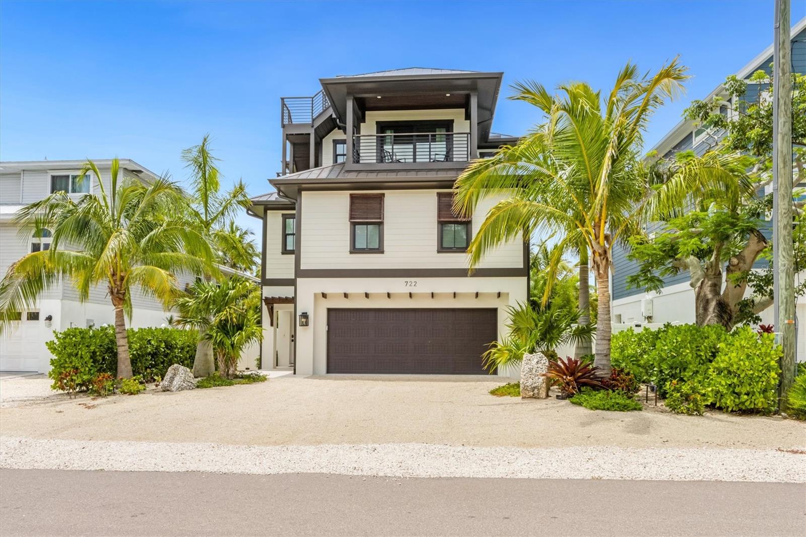 Luxury Island life at it's best! This stunning coastal home features 4 bedrooms and 4.5 baths and has a roof top with Gulf views!! Designed with an open living concept and custom detailed kitchen, you will fall in love! The home features wood grained tile that is perfect for island living, custom trim throughout, and comes turnkey furnished with unique designer details minus small list of exclusions. You will love the fun furnishings from colorful wallpaper, built in bunk beds, colorful tile throughout, custom ceilings and more. The amazing outdoor relaxation space is surrounded by tropical landscaping and features a sparkling heated pool with a large sun shelf & spa, and plenty of entertaining areas. Cool down under the covered area and watch TV and relax. This is a great investment opportunity to own your piece of paradise with annual rental income. Enjoy blue water Gulf views and 360 island views from the rooftop deck. Prime location on the North end of Anna Maria Island close to everything this area has to offer. Schedule your private showing today!