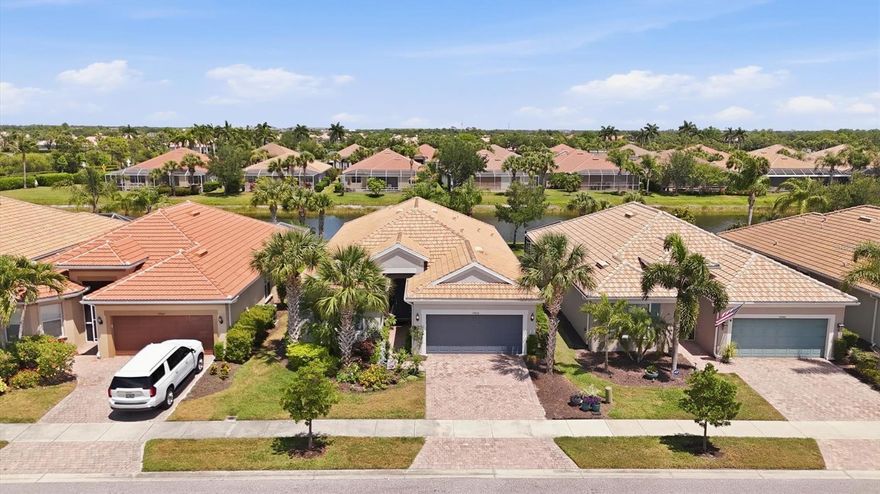 Welcome to IslandWalk at the West Village, a premier resort-style community offering luxury living and picturesque waterfront views. This spectacular Tifton Model waterfront home features 2 bedrooms, 2 bathrooms, and 2 versatile bonus rooms in a desirable split floor plan design.

The open-concept layout seamlessly connects the living room, dining room, and kitchen, creating a spacious great room that opens to an extended screened-in waterfront lanai beautifully enhanced with pavers for added charm and ambiance. The kitchen showcases stunning water views and features a large eat-in island, granite countertops, abundant cabinetry, a spacious pantry, dual sinks, and plenty of workspace for entertaining and everyday living.

The primary suite offers a relaxing retreat with an en-suite bathroom featuring dual sinks, a walk-in shower, private water closet, and a large walk-in closet. Neutral tile flooring laid diagonally flows throughout the main living areas, while plantation shutters add elegance throughout the home. The second bedroom features wood flooring and is conveniently located near the guest bathroom and two bonus rooms, perfect for an office, den, hobby room, or additional guest space.

Additional highlights include a large laundry room complete with folding station and cabinetry, as well as a spacious 2-car garage.

This exceptional home offers the perfect blend of comfort, style, and breathtaking waterfront living, whether enjoyed year-round or seasonally.

Living in IslandWalk provides a true resort-style lifestyle with an abundance of amenities including geothermal pools, lap pools, spas, Har-Tru tennis courts, pickleball, bocce ball, basketball courts, playground, dog park, two state-of-the-art fitness centers, a library, outdoor pavilion with BBQ grills, and a 24-hour staffed gated entrance. The community also features on-site HOA staff available seven days a week to assist residents and guests.

Golf carts are permitted throughout the community and may also be driven throughout Wellen Park when properly registered. Residents enjoy exclusive access through a private back gate to Downtown Wellen Park, featuring a vibrant marketplace anchored by Publix, the Atlanta Braves Spring Training Stadium, restaurants, shopping, and entertainment.

Conveniently located approximately 4 miles from I-75, this home offers easy access to pristine Gulf beaches, airports, Historic Venice Island, dining, shopping, and cultural attractions.

Schedule your private showing today and experience this beautiful waterfront home for yourself.