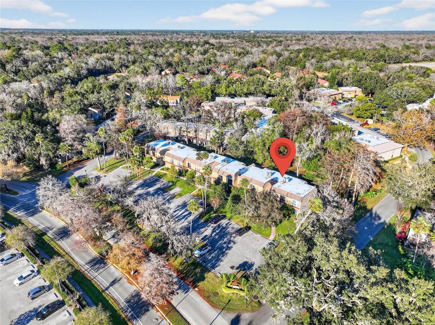 One or more photo(s) has been virtually staged. Stunning upgraded corner-unit with extra privacy and garden views! Enjoy wood-look flooring, an open kitchen with granite countertops, stainless steel appliances, bar area plus a wet bar with built-in wine cooler, perfect for entertaining. Plantation shutters throughout the living room, tinted windows, and a newer tankless electric water heater add comfort and efficiency inside the laundry area. Relax on the tiled screened patio, make use of the storage area on your 1st floor unit and enjoy low-maintenance living in a resort-style community with pool, tennis/pickleball courts, trails, playground, and water views. HOA covers exterior maintenance, roof, and common areas. Ask for the seller's provided list of upgrades and improvements.