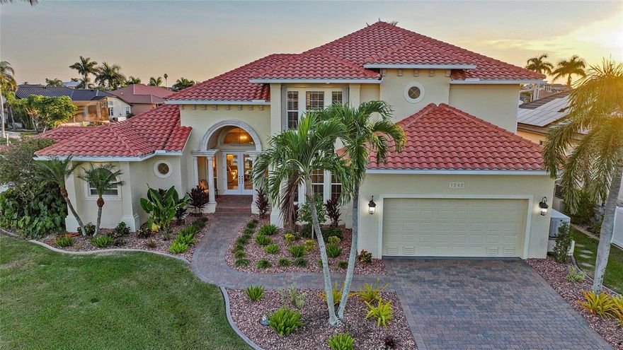 Welcome to the pinnacle of Punta Gorda Isles waterfront luxury—a breathtaking 4 bedroom, 3 bathroom, 2 half-bath residence with a den, perfectly positioned on an exceptional south-facing tip lot offering 173 feet of city-maintained concrete seawall and unparalleled panoramic water views. Designed for the discerning homeowner who expects the extraordinary, this estate delivers elite craftsmanship, sophisticated amenities, and world-class boating right in your backyard.
Step inside and be immediately captivated by the grand, airy layout where refined finishes and thoughtful architectural lines guide you toward the heart of the home. A 500-bottle, temperature-controlled wine room—with refrigeration fully independent from the rest of the home—anchors the residence in true luxury and sets the stage for elevated living and entertaining.
The great room unfolds through zero-corner sliding glass doors, erasing the boundary between indoors and outdoors and revealing an expansive, resort-style lanai. Outside, a travertine pool deck surrounds a stunning PebbleTec saltwater pool, complete with a solar-powered pump and heater, built-in grill, and a dedicated half pool bath for convenience. Whether hosting sunset gatherings or enjoying peaceful mornings by the water, this outdoor oasis is designed for ultimate relaxation.
For boating enthusiasts, this property is simply unmatched. Enjoy two private boat lifts—including a 55,000 lb catamaran lift and a 10,000 lb lift—positioned along the wide canal with immediate, unobstructed deep-water access to Charlotte Harbor and the Gulf. Wide turning basins, expansive waterfront views, and a quiet corner location elevate this residence to a class of its own.
Peace of mind meets modern resilience with a new roof, accordion shutters, storm covers, and a 26 kW Generac Whole House Generator connected to a 250-gallon buried propane tank. A rare air-conditioned outdoor storage room adds practicality without compromising luxury.
Inside, each bedroom is generously sized, beautifully appointed, and designed with comfort in mind. The den offers flexibility for a private office, library, or quiet retreat. Every space flows effortlessly, showcasing the home’s elegant transitions, natural light, and attention to detail.
This is more than a residence—it is a lifestyle. A luxurious, meticulously maintained waterfront sanctuary offering unmatched boating, lavish amenities, and the coveted PGI location you’ve been waiting for.