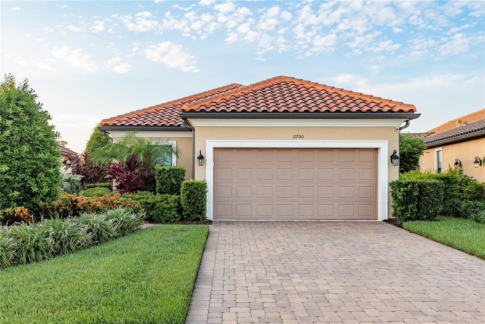 Welcome to Your Dream Home at Esplanade at Starkey Ranch! Discover the epitome of maintenance-free living in the coveted gated community of Esplanade at Starkey Ranch! This exquisite Arezzo model single-family villa, built in 2018, is perfectly nestled on a serene lake-view lot at the end of a peaceful cul-de-sac. Key Features Include:
-Spacious Living: With 3 bedrooms, 2 bathrooms, a den, and a generous 2-car garage featuring a 4-foot extension and stylish epoxy flooring, this home offers ample space for relaxation and entertainment.
-Gourmet Kitchen: Calling all chefs! The open-concept kitchen is a culinary masterpiece, showcasing elegant Windemere Cambria quartz countertops, Windsor maple cabinets, and a stunning Botticino marble backsplash. Top-of-the-line GE appliances, including a convection microwave oven, gas range with a non-stick griddle, and a side-by-side refrigerator, make cooking a delight.
-Inviting Great Room: The kitchen flows seamlessly into the spacious great room, where sliding glass doors lead to a magnificent 20x30ft stamped concrete fully screened patio. This oversized patio includes custom-made electric privacy screens and a Bar! Enjoy breathtaking lake views in your private outdoor oasis, perfect for morning coffee or evening gatherings.
-Luxurious Master Suite: Retreat to the opulent master suite featuring dual walk-in closets, a spa-like frameless glass shower, and elegant quartz countertops—your personal sanctuary awaits!
-Thoughtful Details: Experience the warmth of Harvest Wheat wood-look tile flooring, plush spill-guard carpet in all bedrooms, and custom plantation shutters that add both style and functionality. Aluminum Hurricane shutters ensures the homes safety if a storm arises.
-Pet-Friendly Features:
Designed for pet lovers, this home includes a 4-foot aluminum fence with puppy picket, a built-in doggy door, and a custom dog run—an exceptional find for a lake-view lot! This is a one of a kind find in this neighborhood!! The deluxe laundry room, outfitted with rustic cabinets and a farmhouse sink, is ideal for washing up after outdoor adventures.
Outdoor and Community Amenities:
Entertain in style with a pre-plumbed outdoor kitchen featuring a commercial-grade setup. The professionally landscaped yard sets the perfect ambiance for romantic evenings under the stars.
Enjoy peace of mind with a host of resort-style amenities exclusive to Esplanade residents, including concierge service, a state-of-the-art fitness center, resort and resistance pools, tennis and pickleball courts, shuffleboard, and dog parks. Esplanade residents also are welcomed at all Starky Ranch amentities!
-Community Lifestyle:
Nestled in the award-winning Starkey Ranch community, you’ll have access to 22 miles of scenic trails and 800 acres of conservation land. Explore the nearby JB Starkey Wilderness Preserve and relish the convenience of shopping, dining, stunning beaches, and Tampa International Airport just a short drive away. Don’t let this rare opportunity slip away! Schedule your showing today and experience the unmatched luxury and convenience of life at Esplanade at Starkey Ranch!