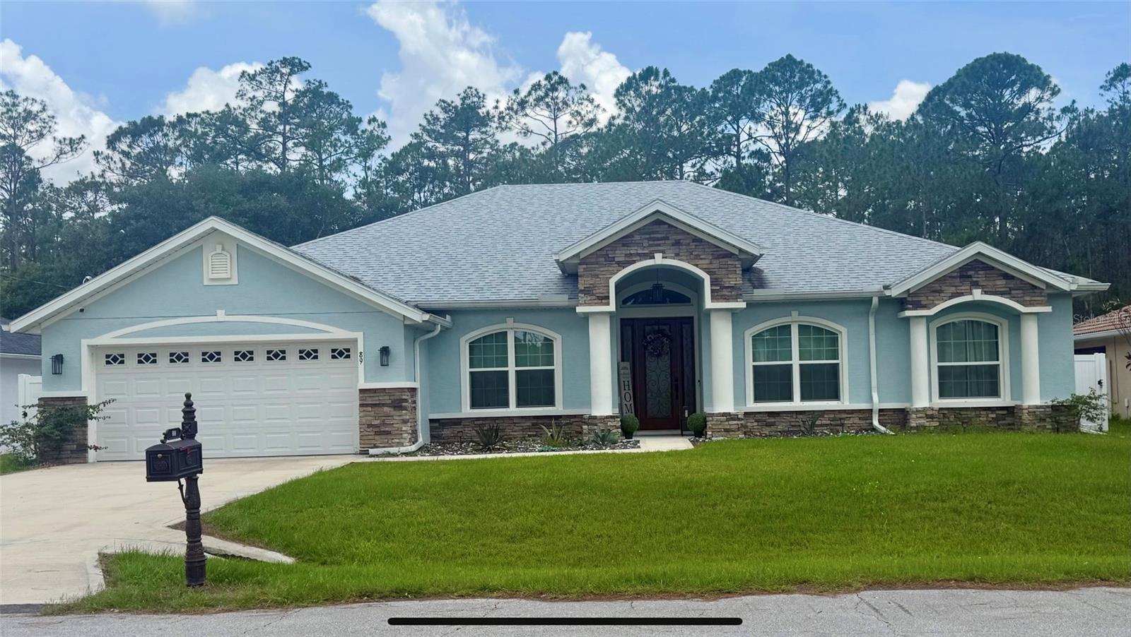Priced aggressively due to Seller relocating. Current Mortgage on the property has a rate of 3.25% and may be assumable by the Buyer. Built in 2022 by SeaGate Homes, this 4 Bedroom 3 Bath house (expanded Summerland model) features a Primary Bedroom with an attached sitting room, dual walk-in closets, a second bedroom with an attached bathroom, a cafe area, covered lanai, a den, a study, an open kitchen with an island, wine fridge, a built-in range hood, and a large walk-in pantry. Fully fenced back yard with three crepe myrtles and no rear neighbors. The sun rises in the front of the home, and the sun sets in the rear of the house. There is a laundry room/utility room inside of the home. All appliances in the home convey. Roof, HVAC, and all appliances are from 2022.
Approximately 9.4 miles from the beach, 0.8 miles to an entrance of the Lehigh Greenway Rail Trail, 3.6 miles from the Flagler County Fairgrounds, and 12.4 miles from Hammock Beach Golf Resort & Spa. Numerous gas stations, restaurants, a Publix and a Target are located within 5 miles from the property.