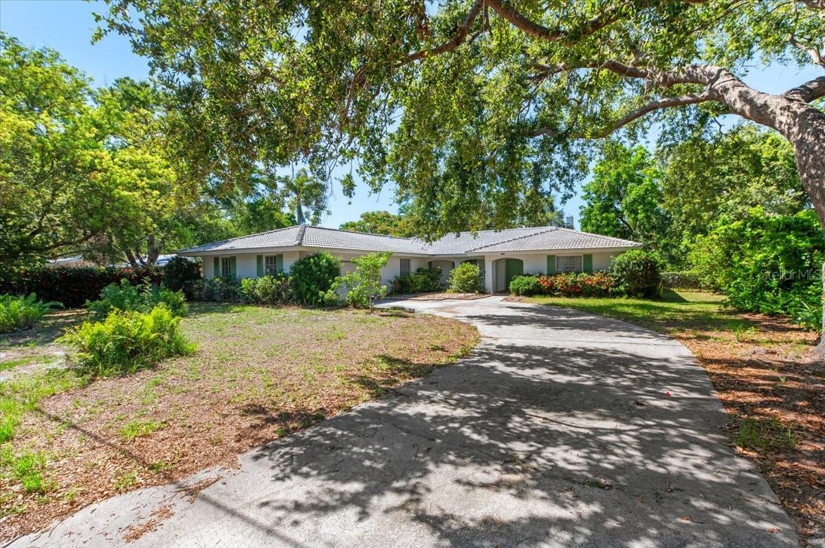Opportunity knocks with this quiet West of Trail location! Located 10 homes from the water, this home is set on an expansive 98 x 125 ft lot offering exceptional potential—whether you’re looking to renovate, rebuild, or invest in one of Sarasota's most desirable locations. Tucked into a tree-lined street within the favorable X flood zone, this 3-bed + den, 2-bath home spans 2,165 square feet and features a split floor plan, a large 2 car garage, and solid bones ready for transformation. The layout offers a great flow, and with vision and updates, it could easily be reimagined into a stunning residence that maximizes its generous footprint and location. While the interior reflects a bygone era, the roof was replaced in 2014 and AC updated in 2018. Whether you're a builder eyeing your next custom home project or a buyer ready to bring new life to a classic structure, this is a canvas waiting to be shaped. Just seconds from the North Siesta Key Bridge, and a hop, skip, and a jump from Sarasota Memorial Hospital, Southside Village, and the vibrant energy of downtown Sarasota. Don’t miss your chance to own in one of Sarasota’s most established and sought-after neighborhoods. Whether your dream is renovation or new construction, now's the time to make your move! Call for a private showing!