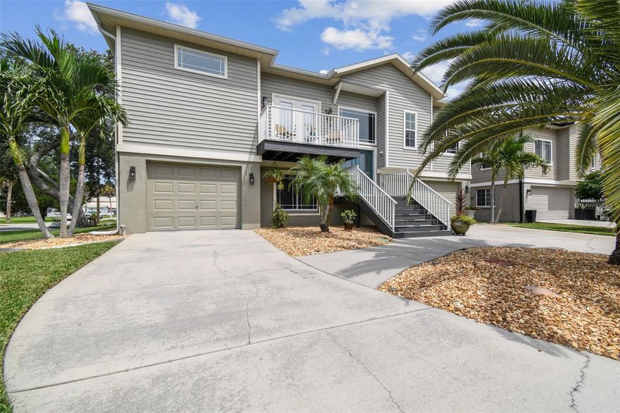 Welcome to this beautifully maintained, elevated block home offering the perfect blend of style, function, and location, just one block from a private deeded boat ramp with quick and easy access to the Gulf! Featuring a new roof (2024), impact-resistant windows, and no HOA, this property is completely move-in ready and worry-free. The massive 1,400 sq. ft. garage is ideal for parking, boat or recreational vehicle storage, and even a workshop space. Inside this freshly painted home, discover a functional and aesthetically pleasing layout with a split bedroom floorplan featuring a large primary suite with his/her closets and a spacious bathroom. The main living area boasts a well-laid out kitchen with updated stainless steel appliances (refrigerator/microwave 2024) and an eat-in area, an expansive open-concept family room, and a separate formal dining area, perfect for entertaining. Outside, enjoy a beautifully landscaped fenced-in yard with both a front balcony and a relaxing, large screened-in back porch with dual french-door entry that spans across the entire length of the home - perfect for a morning cup of coffee or unwinding at the end of the day. Other major updates include a newer HVAC (2019), water softener (2024), hot water heater (2024), and beautiful hurricane-rated front doors (2020). Located close to downtown New Port Richey and convenient to shopping, dining, and medical facilities. Spend your evenings walking to local restaurants or take a golf cart to nearby entertainment spots. This home is the perfect coastal retreat — ready for your next adventure!